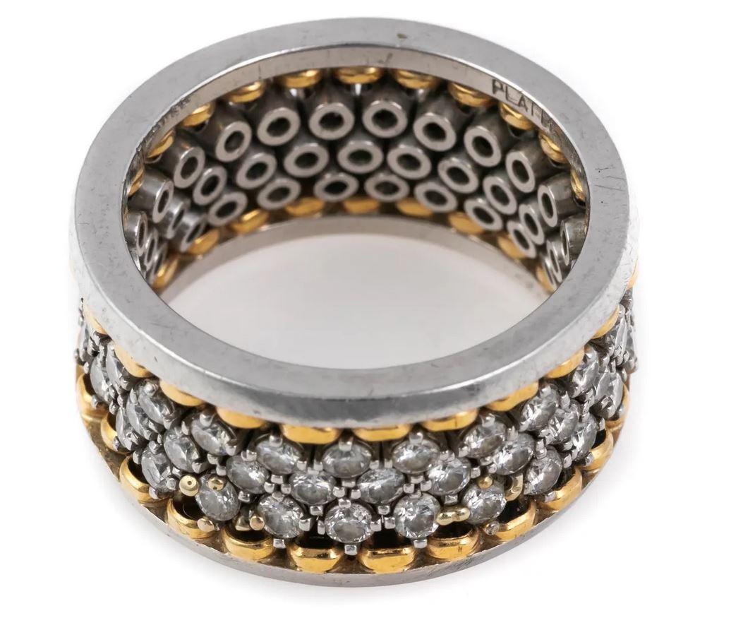 A unique and spectacular diamond ring that is full of sparkle!

This contemporary designer style two tone, wide diamond eternity band ring is crafted with platinum and 18k yellow gold accents, with three rows of round cut diamonds in slightly