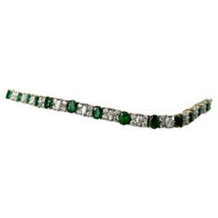 Platinum and 18K Gold Oval Emeralds and Diamonds Bracelet