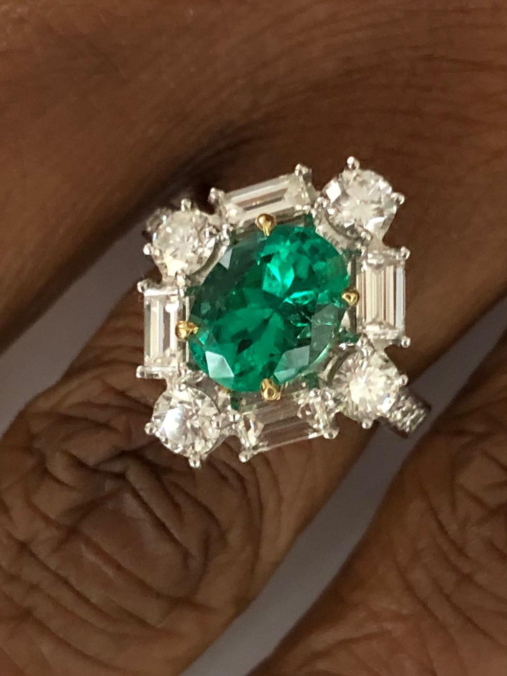 An out of the ordinary design, made in Platinum with 18K Yellow Hold for the prongs to hold this beautiful Colombian Emerald of 2.42 carats and 16 fine quality Diamonds 2.42 carats.

We design and manufacture our jewelry in our workshop, located in
