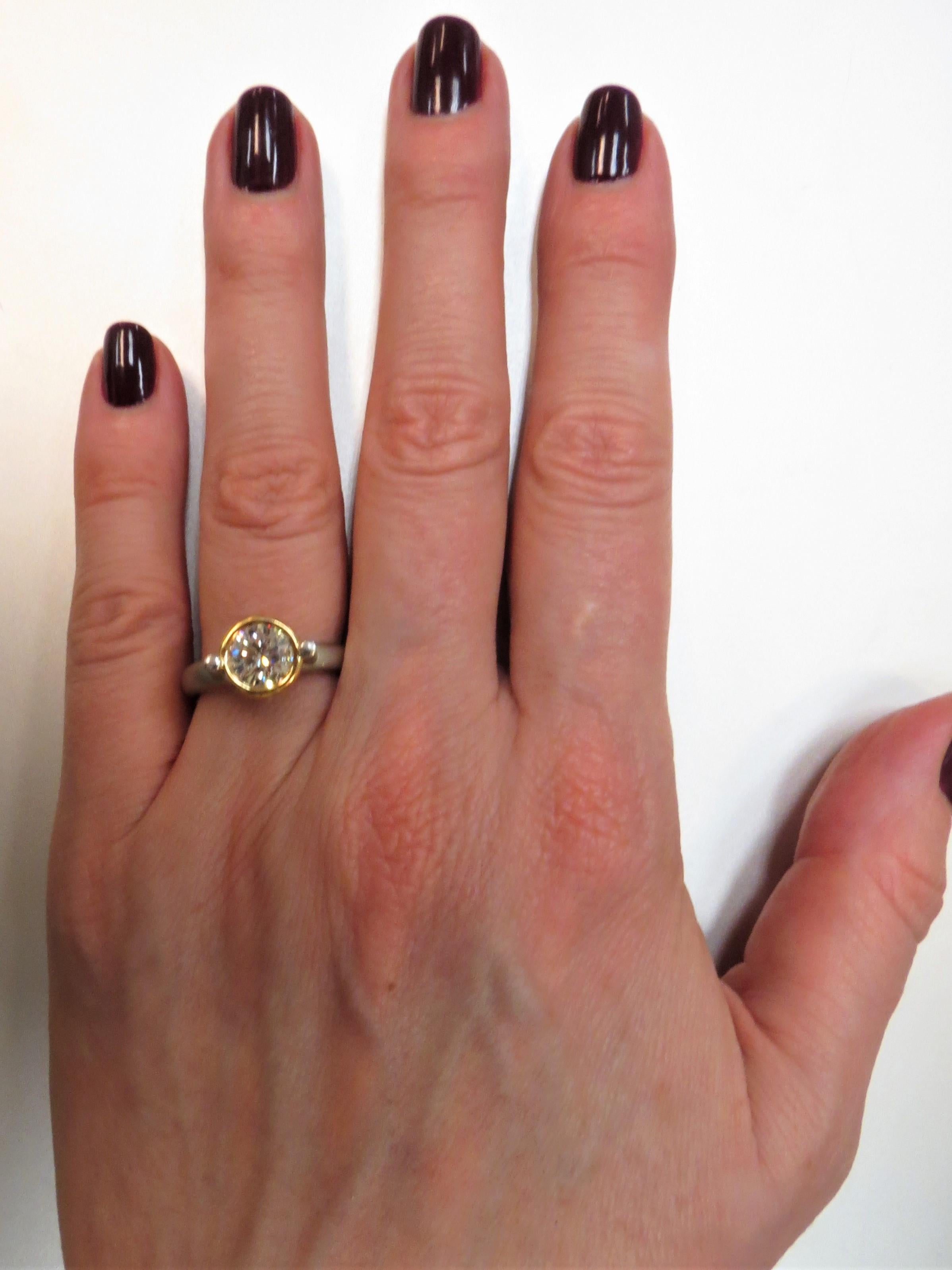 Platinum and 18K yellow gold ring by Whitney Boin, bezel set with one Round diamond weighing 1.24cts, H-I color, VS2 clarity
Finger size 6
Retail $10,500