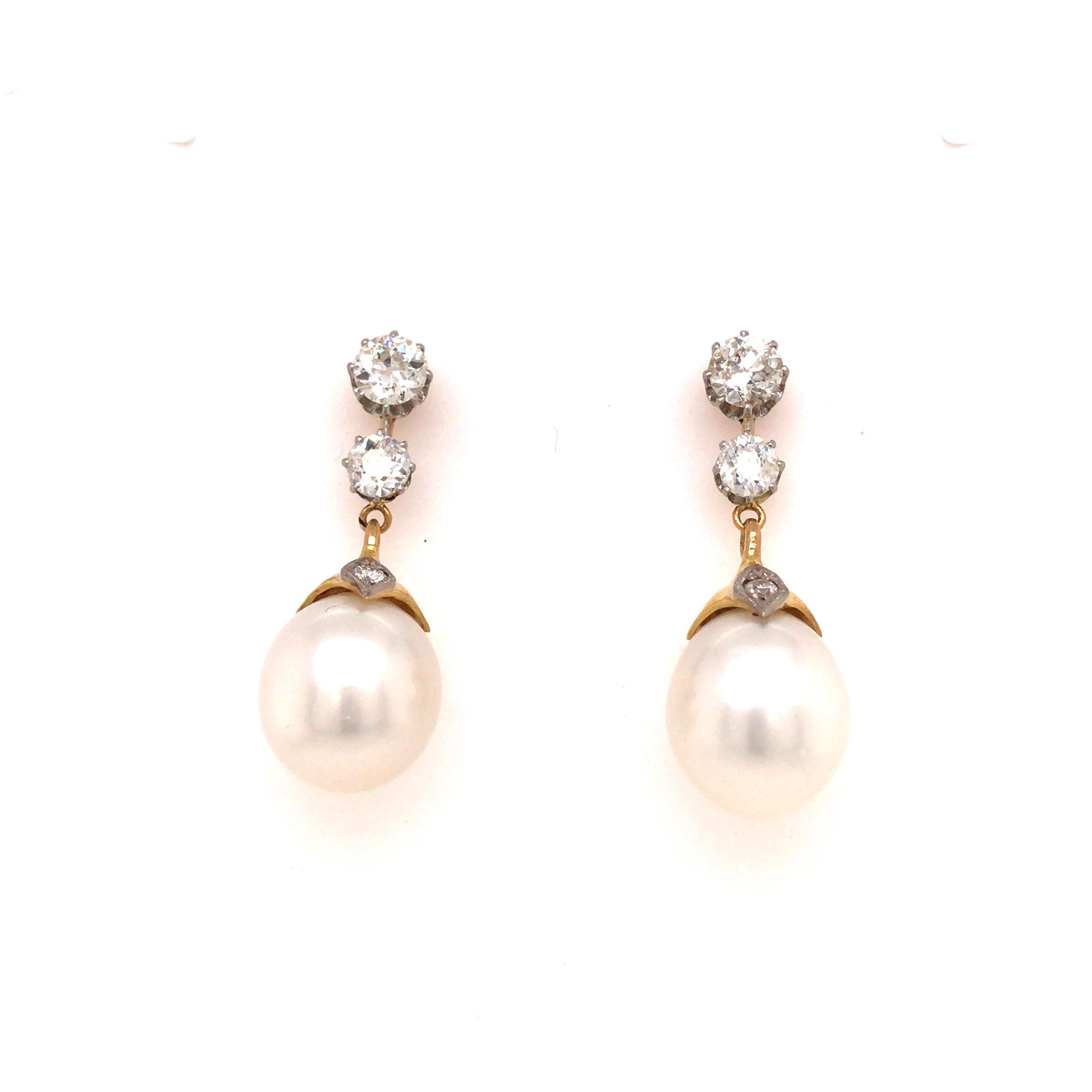 Platinum and 18K Yellow Gold Vintage Diamond and Pearl Drop Earrings .  (6) Round Brilliant Cut Diamonds weighing 1.50 carat total weight, G-H in color, VS in clarity and (2) 12-13mm White Pearls are expertly set.  The Earrings measure 1 1/4 inch in
