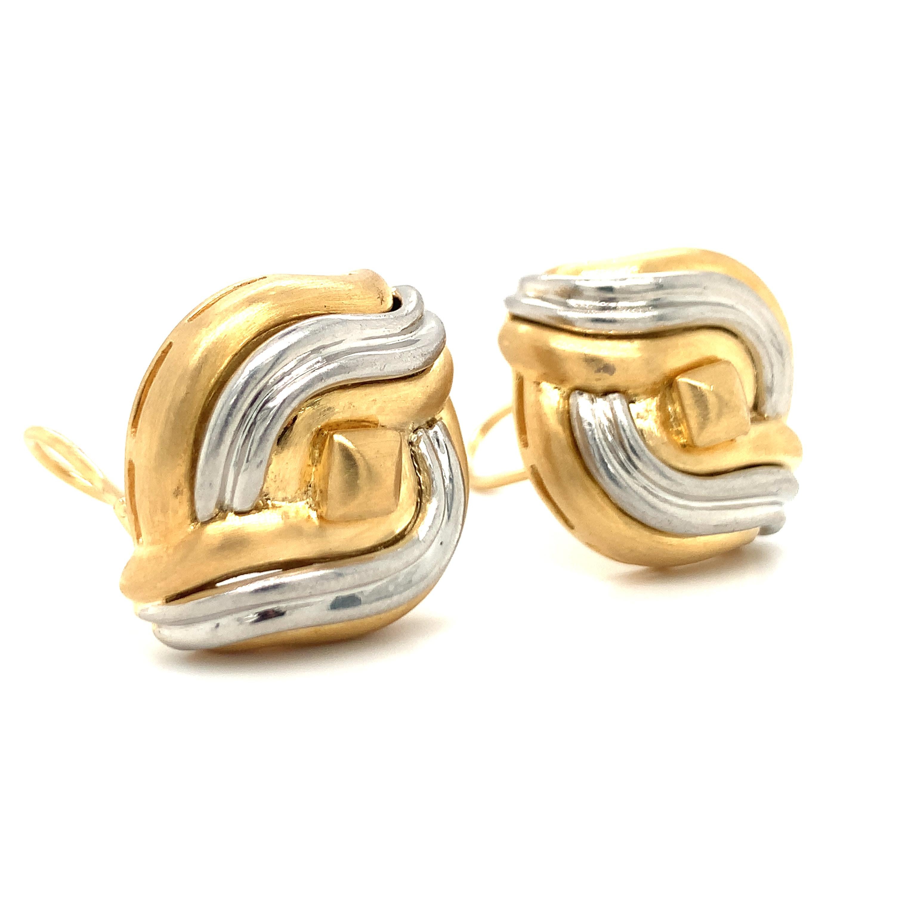One pair of platinum and 18K yellow gold diamond-shaped, wave motif earrings with textured and high polish finish throughout measuring 28 millimeters long in size, with 18K yellow gold omega backs and posts.

Sleek, dimension, showy.

Metal: