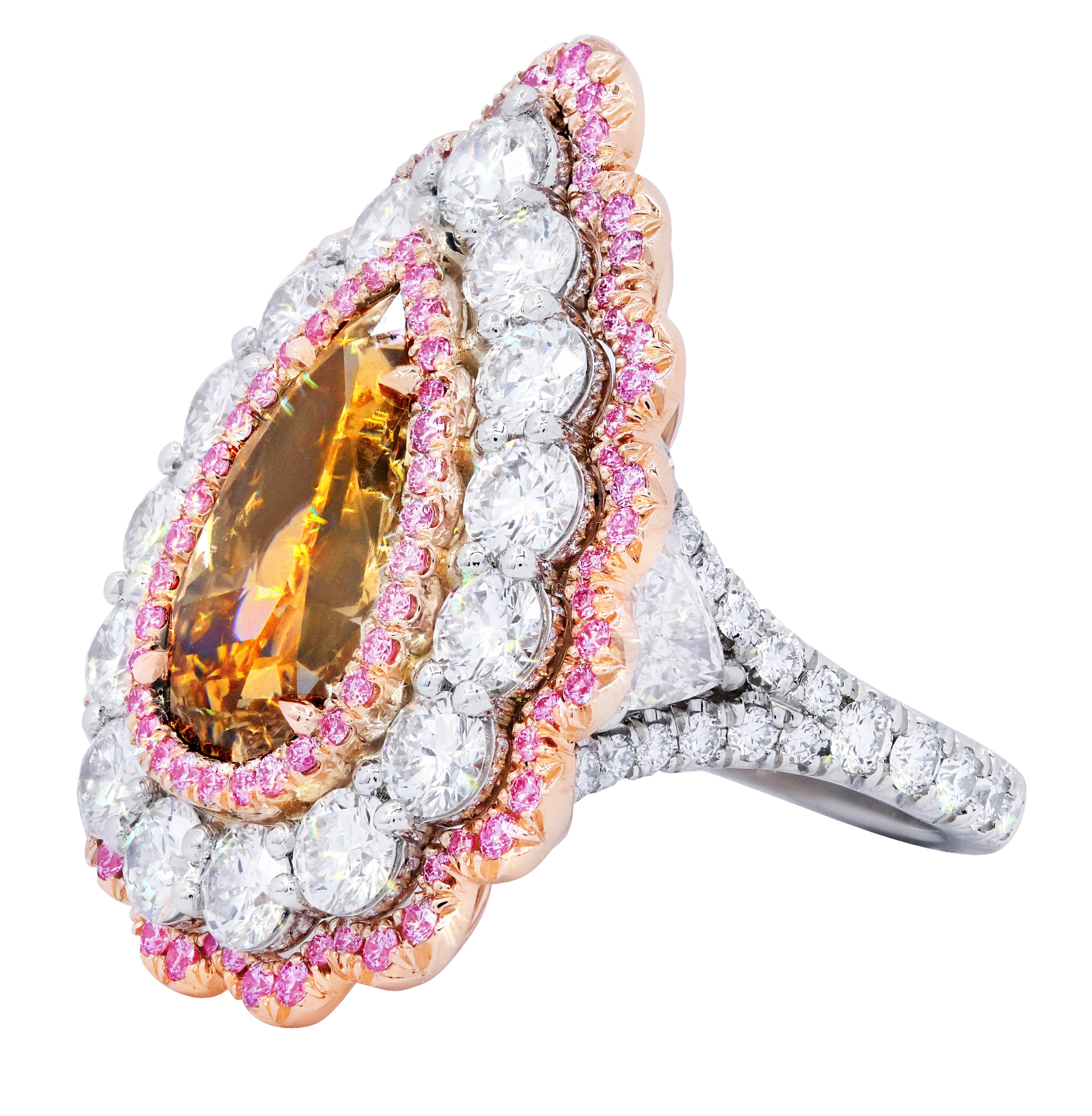 Platinum and 18kt rose gold diamond ring with center fancy brown 5.11ct (psc288) pear shape set in a halo from pink diamonds in micro pave diamond setting with 5.10cts of white big diamonds.
