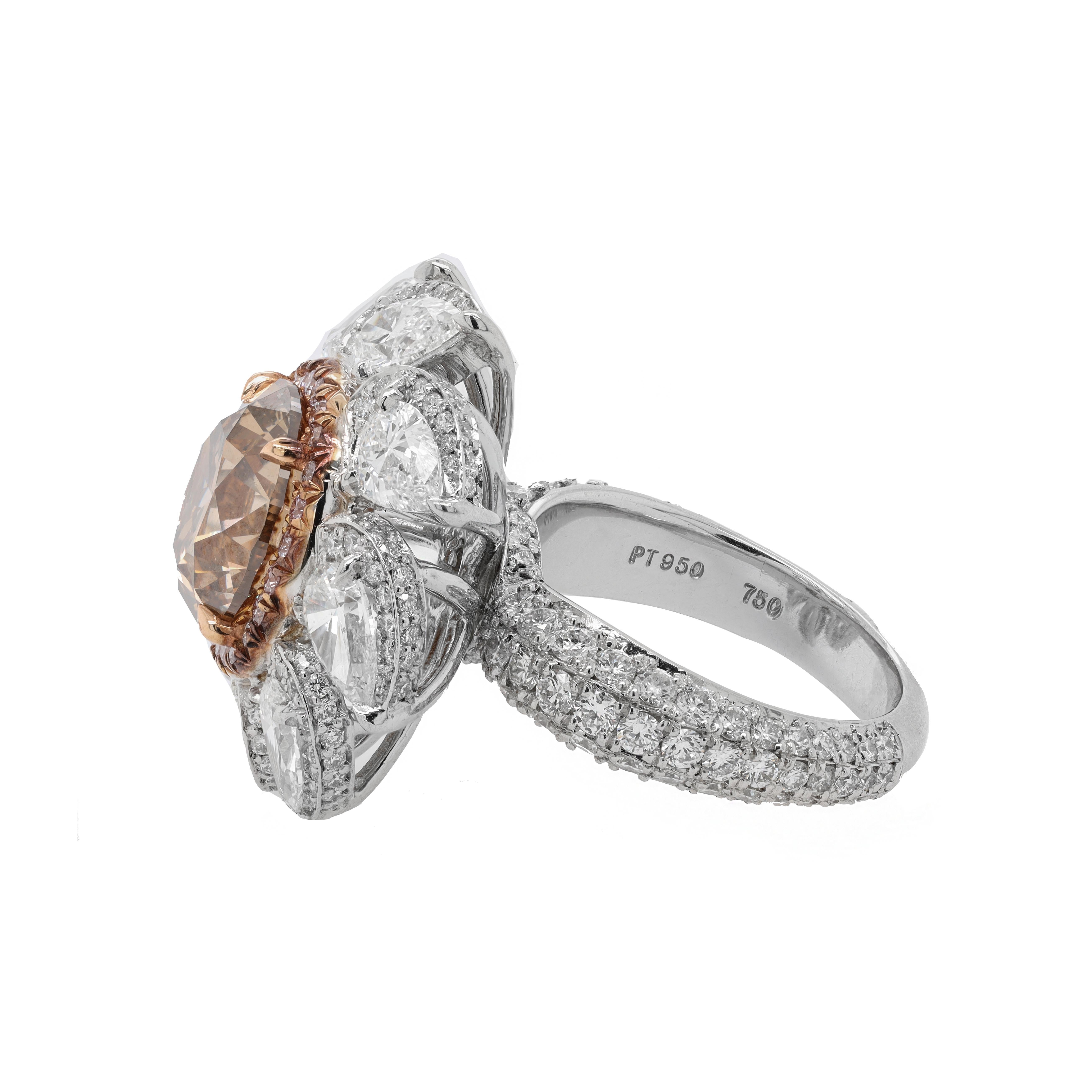 Platinum and 18kt yellow gold fancy diamond ring with center fancy brown 5.52ct (rdc4057) round shape set in a halo from pink diamonds and pear shapes in halos on the sides looks like a flower in micro pave diamond setting with 4.73cts of white