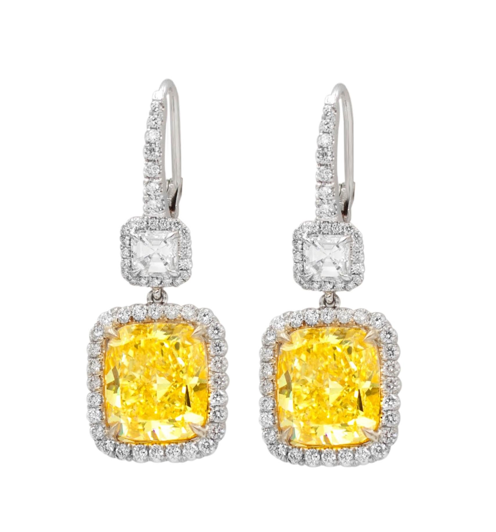 Platinum and 18kt yellow gold fancy yellow diamond earrings, features 10.76ct of two radiant diamonds fly-fy vs and 2.00ct of two ascher cuts diamonds and micropave rd diamonds all around.
