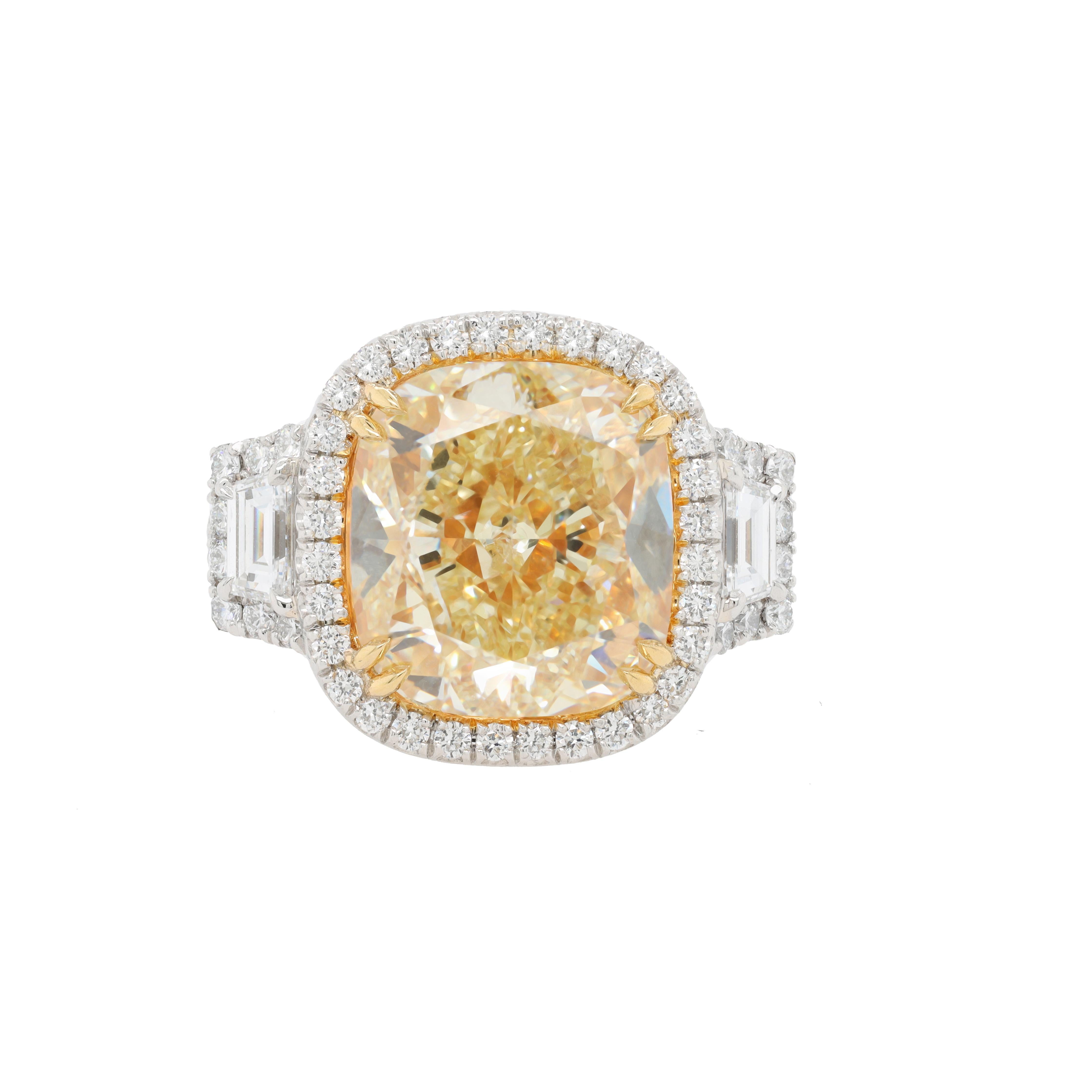 Platinum and 18kt yellow gold diamond handmade ring with 10.05ct cushion center fancy yellow si2 (radc1056) and 1.65ct of step trapezoids and halo diamonds all around and filigree crown and diamonds on the band   
