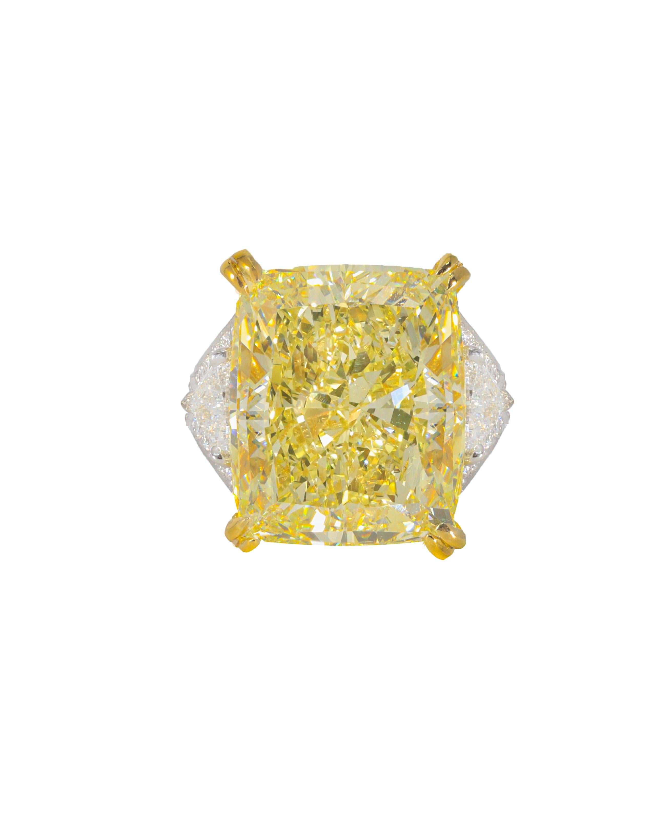 Platinum and 18kt yellow gold custom made ring with center diamond 34.46ct fancy intense yellow vs2 and 3.20cts of trillions and pave set 

