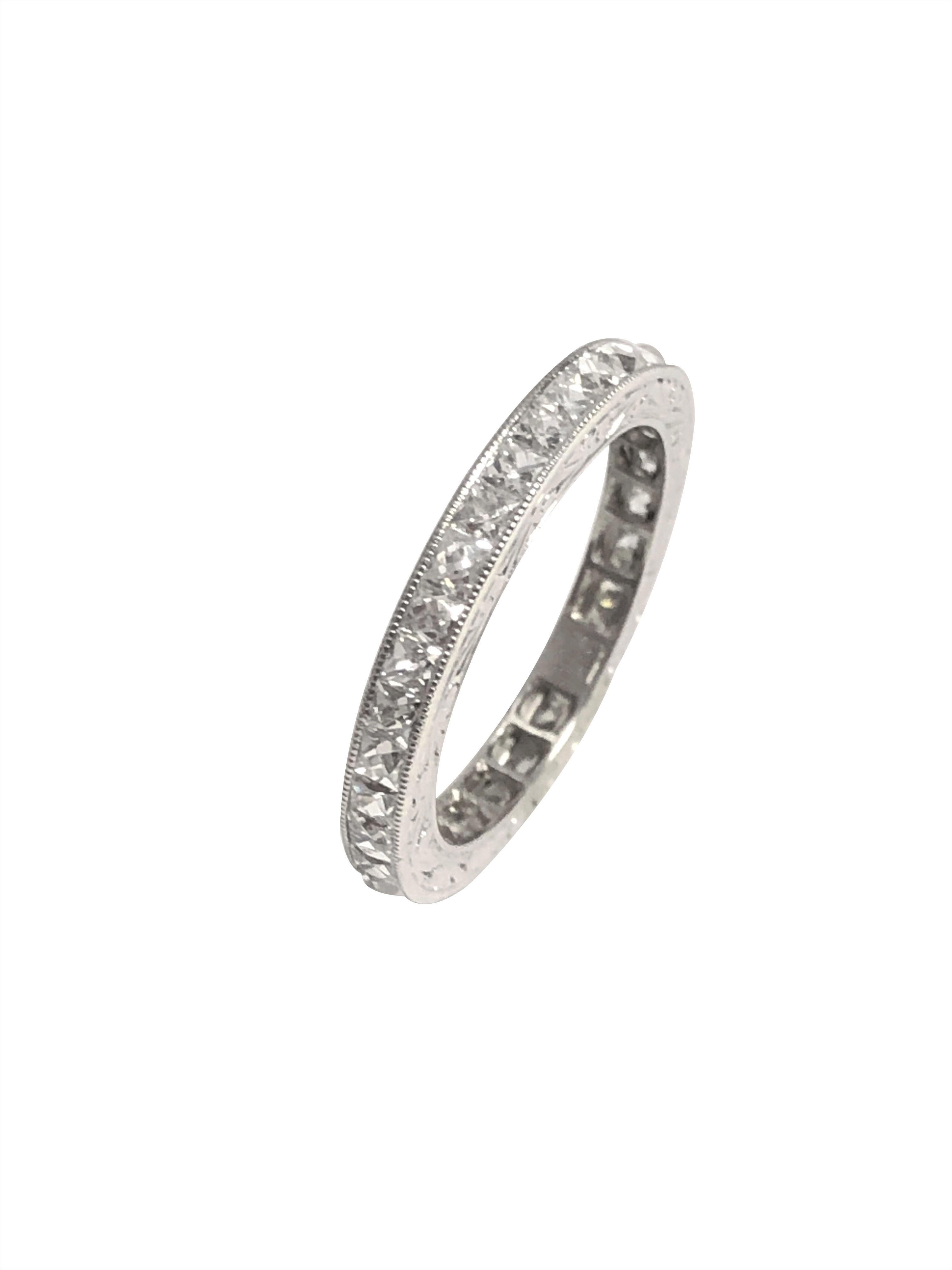 Platinum and French cut Diamonds Eternity Band Ring, measuring 2.5 M.M. wide and set with French cut Diamonds totaling 2 Carats and Grading as G - H in color and VS in clarity, having fine hand engraved design work and is a finger size 6 1/4. 