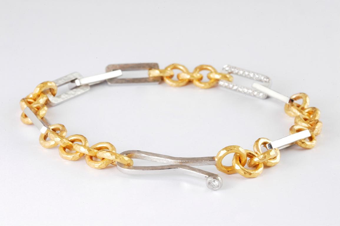 Platinum and 22 Karat gold mixed handmade link bracelet with channel set  brilliant cut diamond link approx 0.20cts total  handmade in London by renowned British jeweller Malcolm Betts using ancient techniques. The channel set diamond link nestles