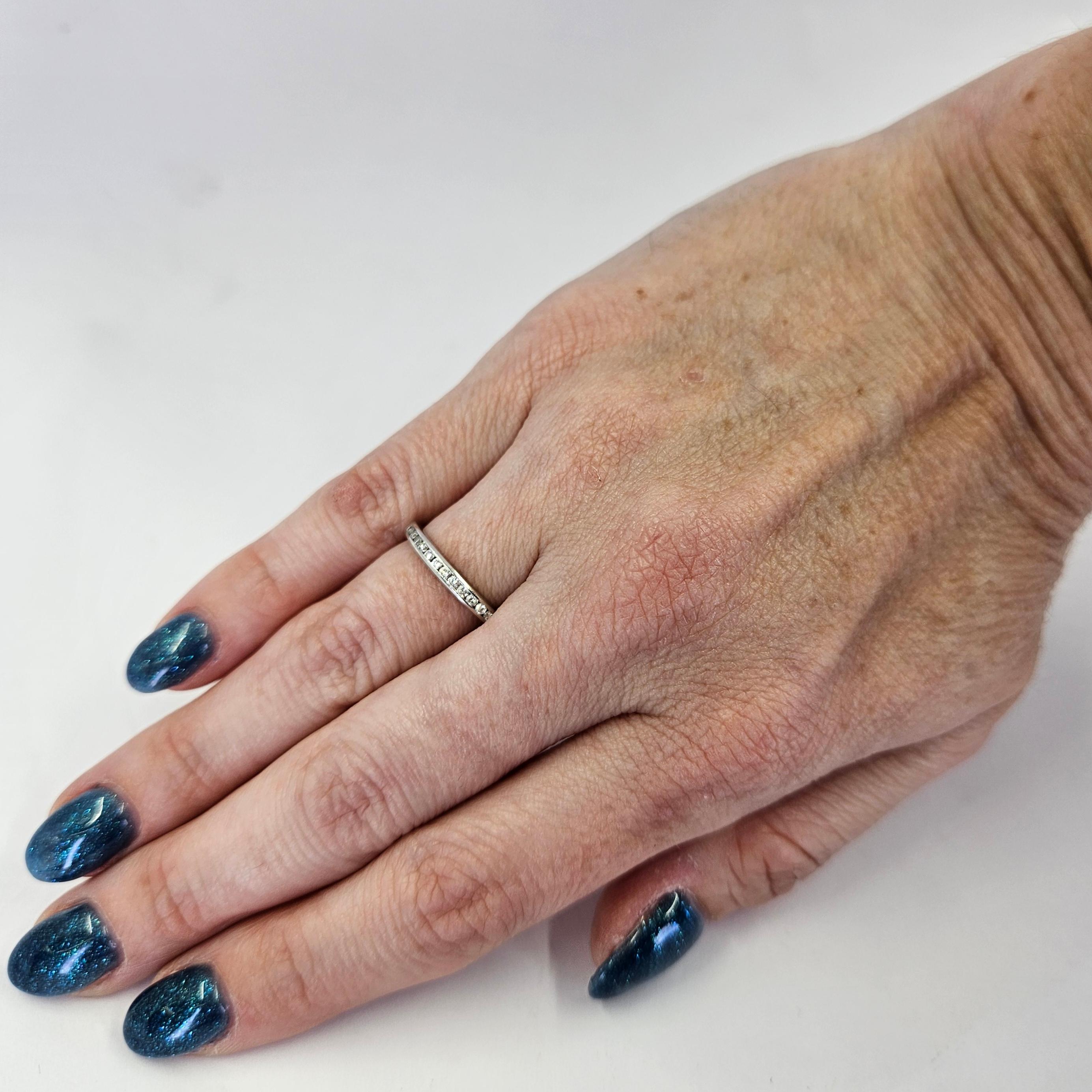 Fascia in platino con canale largo 2,3 mm con 15 diamanti rotondi taglio Brilliante di purezza VS e colore G per un totale di circa 0,15 carati. Dito misura 6. Include un servizio di dimensionamento, su richiesta prima della spedizione. Il peso