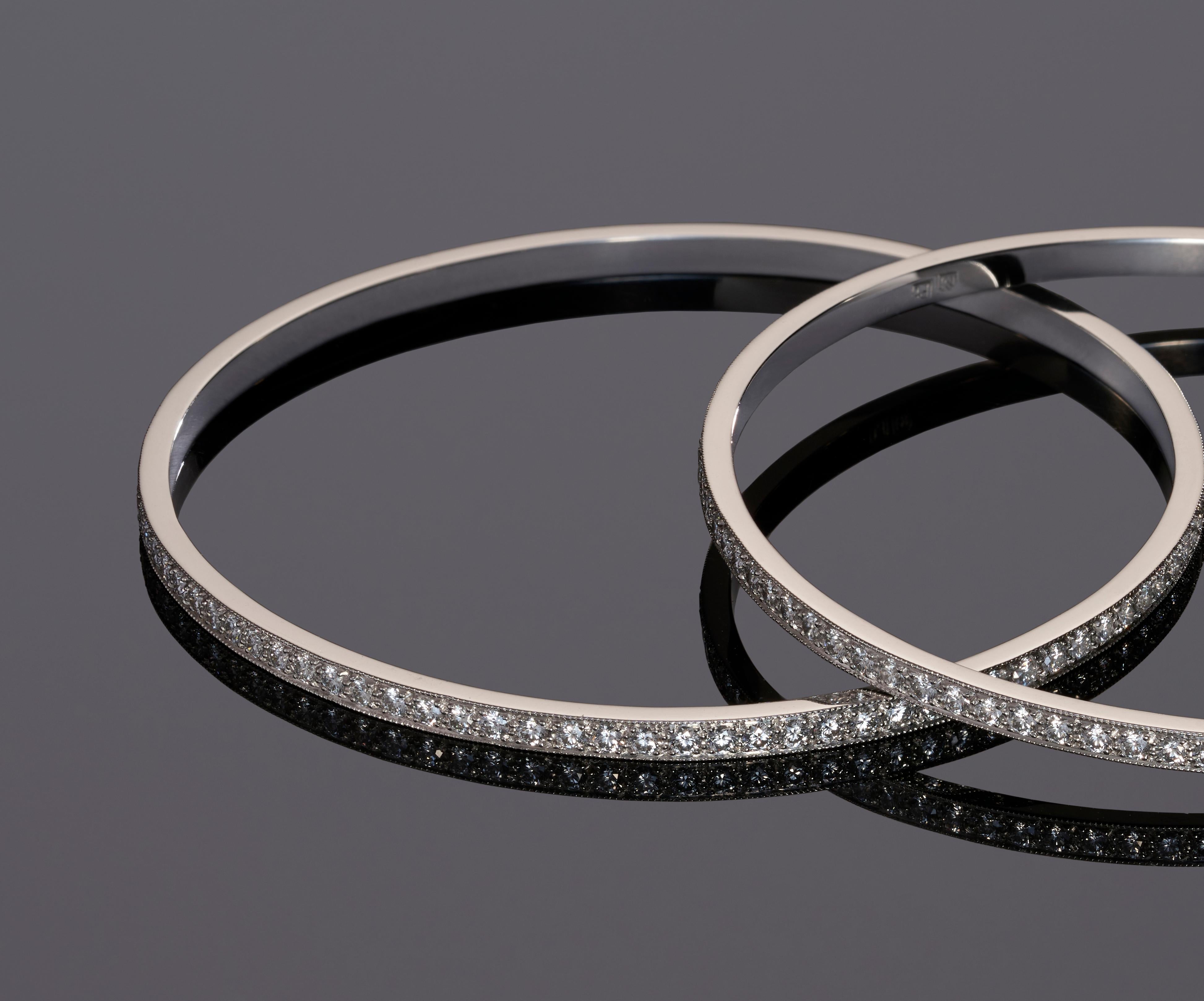 One completely handmade platinum & diamond bangle. The bangle is traditionally thread set with 92 premium, perfectly calibrated round cut diamonds defined by a border of hand millgraining.


Round Brilliant Cut Diamonds:   92=    3.22ct
