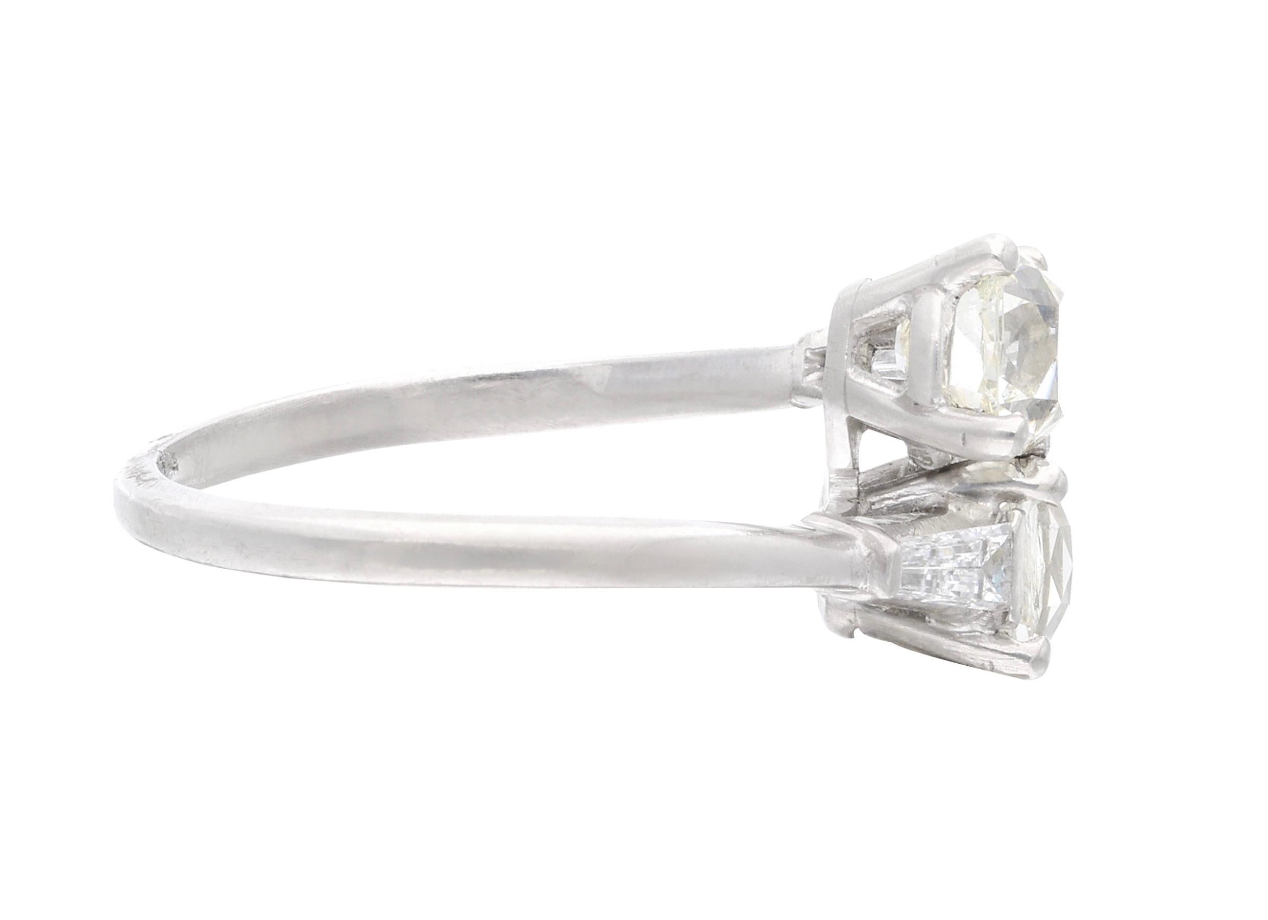 This ring features two bypassing old mine cut diamonds, accented by two tapper baguette diamonds.

- Old mine cut diamonds weighing a total of approximately 1.70 carats
- Tapper baguette diamonds weighing a total of approximately 0.30