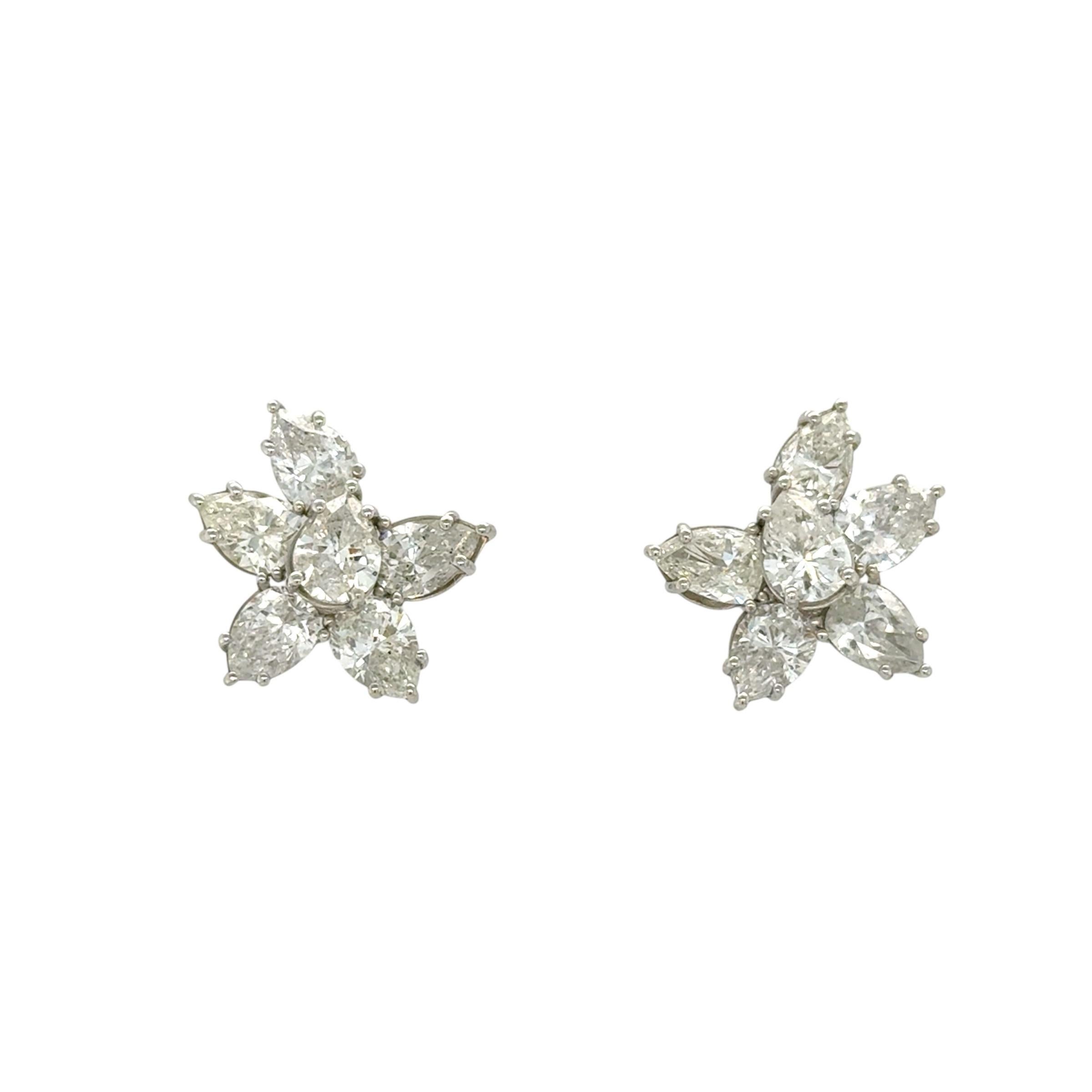 These classic sparkly cluster earrings contain 12 pear shaped diamonds weighing 5.48 carats total. The perfect earring for every collection.

Measurements: 3/4 inch long
Stamp: PLAT
Gross weight: 6.00 grams

Diamond Characteristics (insofar as the