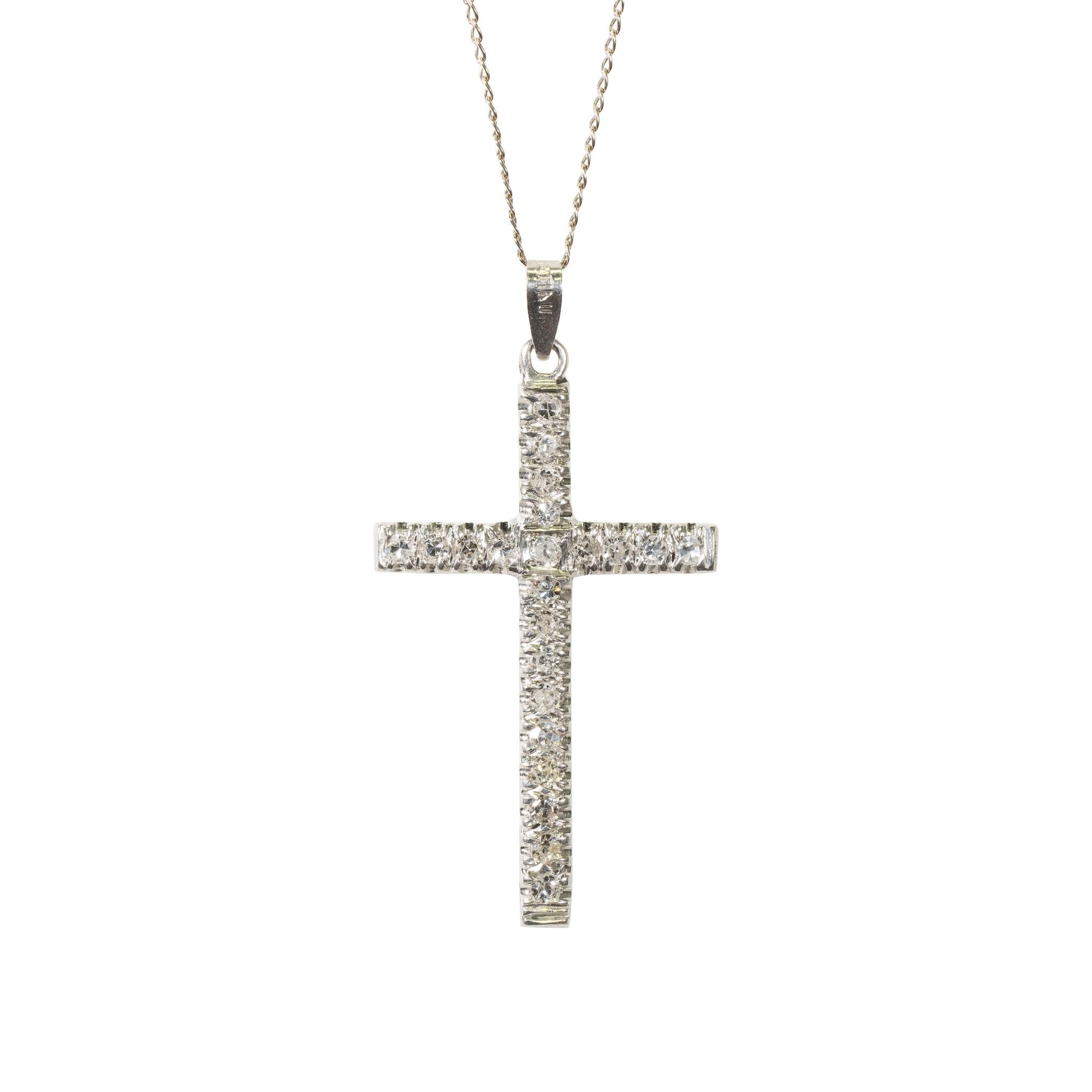 Platinum and diamond cross pendant containing 22 single cut diamonds approximately .50 carats. SL1 Clairity and H Color. Together with an 18