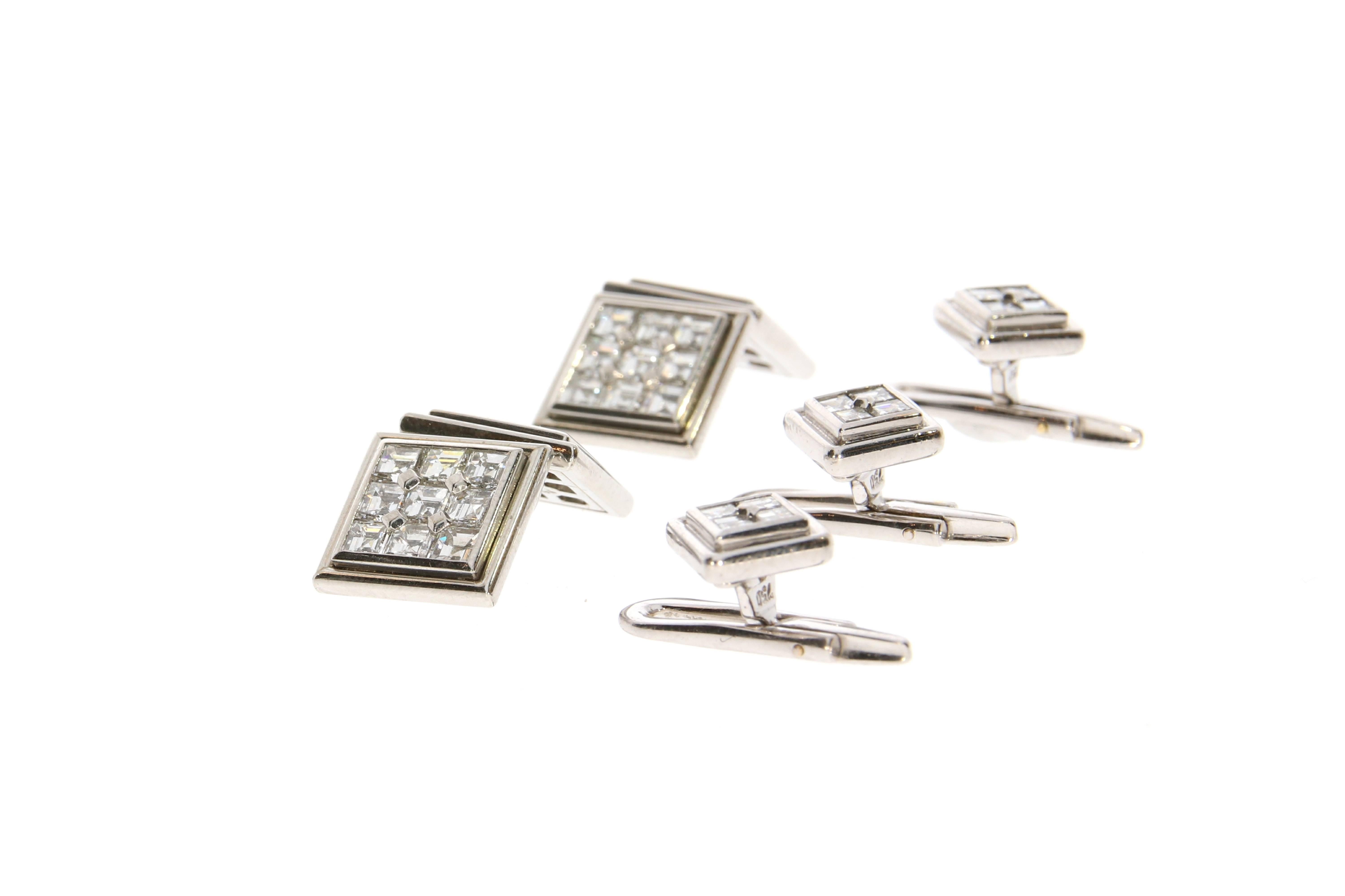 An elegant pair of cufflinks and three additional dress studs. Each platinum cufflink square terminal is set with nine carré cut diamonds, the three additional studs each set with four. With 48 diamonds in total weighing approximately 5 carats.