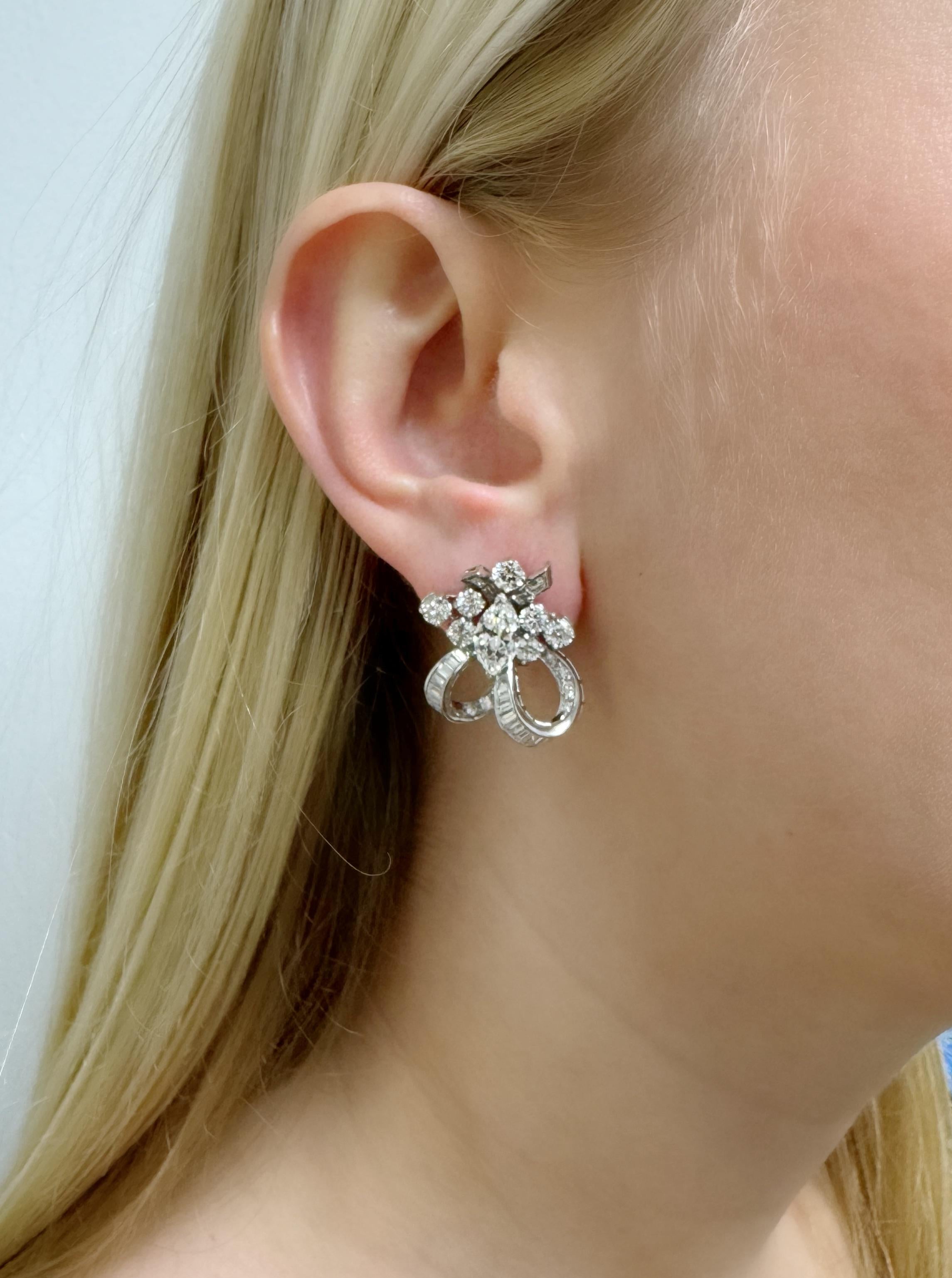 These beautifully crafted earrings contain two marquise cut diamonds weighing approximately 1.95 carats total surrounded by 80 round brilliant cut diamonds and baguette cut diamonds weighing approximately 4.00 carats total, in a looping tie design.