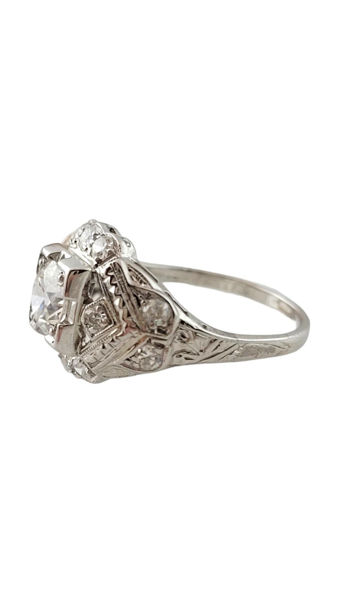 Vintage Platinum and Diamond Engagement Ring Size 4.5-

This sparkling ring features one round brilliant cut diamond (.50 ct.) surrounded by 12 single cut diamonds (.02 ct. each) and set in lovely platinum filigree.
Shank measures 1 mm.

Approximate