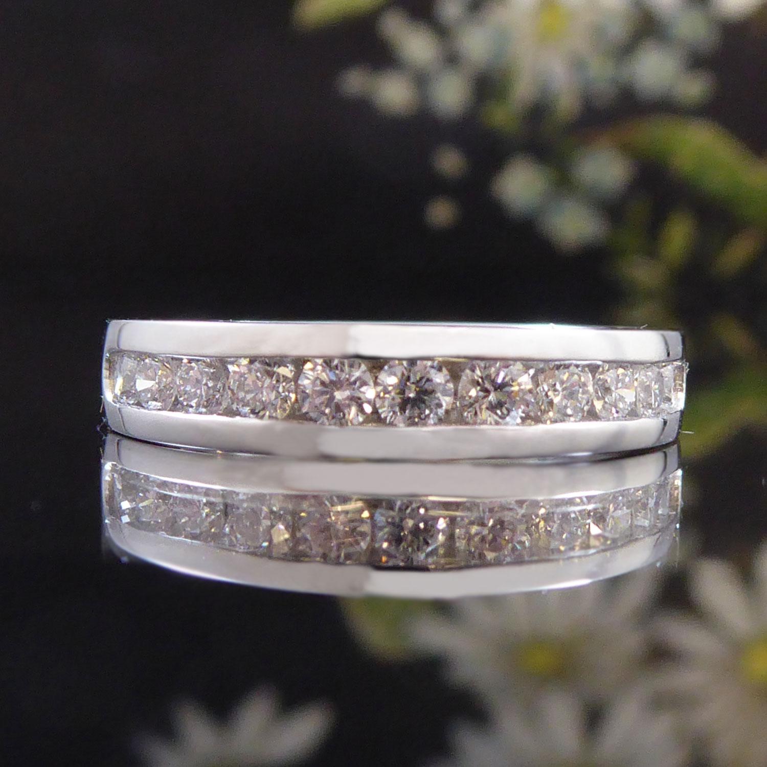 A classic and elegant diamond set band that can be worn as a wedding ring, an eternity ring or stacked next to other narrow band rings.  Set with 0.50ct of brilliant cut diamonds, 11 diamonds in total, arranged across the finger in a channel setting