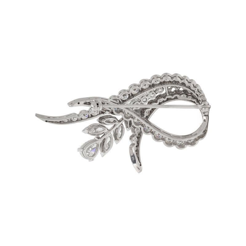 This intricate platinum Flower Petal brooch is set with one pear-shaped diamond, weighing approximately 0.60 carats, six marquise-cut diamonds, weighing approximately 1.20 carats, and numerous round brilliant and single-cut diamonds, weighing