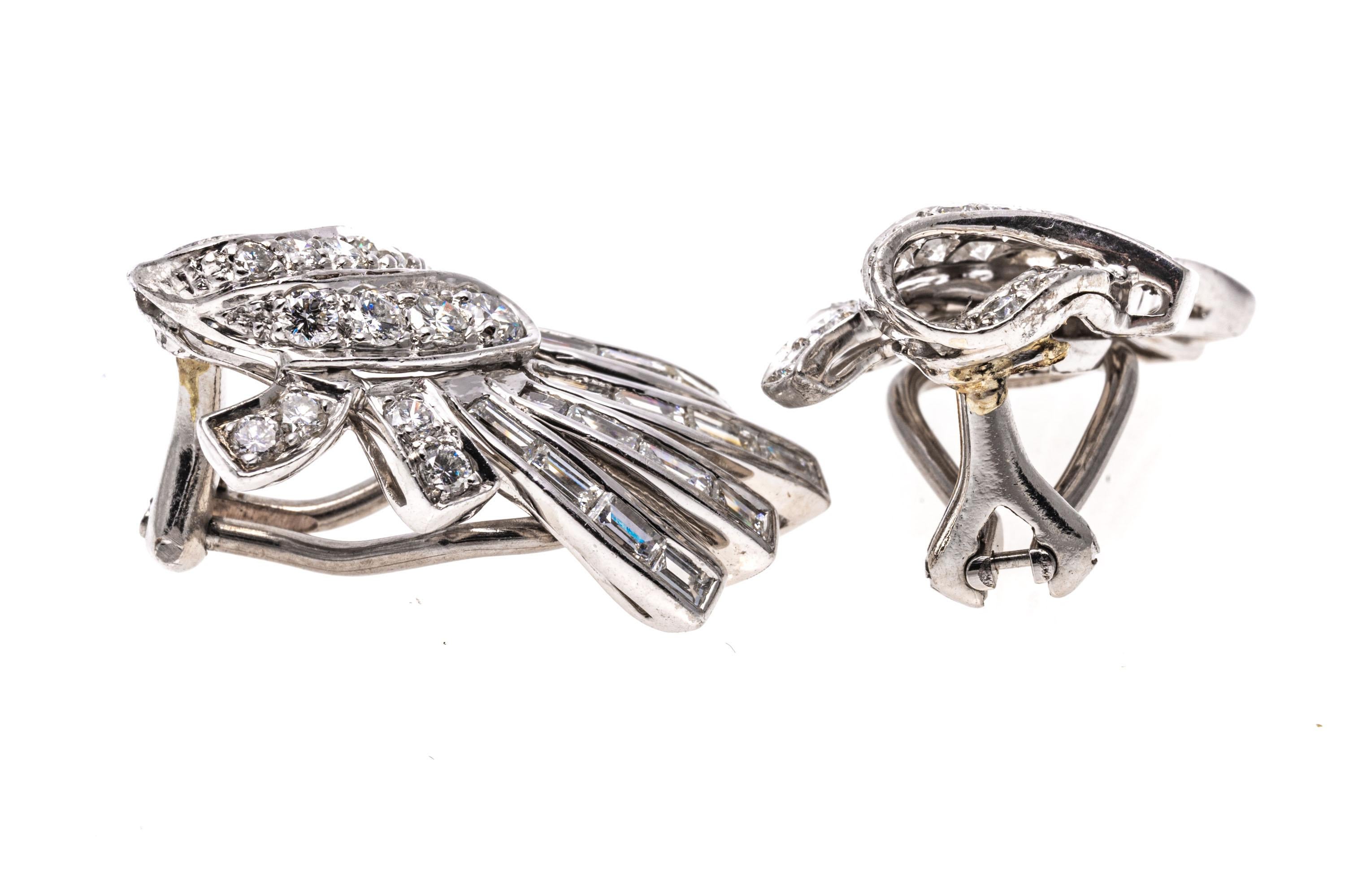 Platinum earrings. These gorgeous earrings are a fringed knot motif, set with rows of channel set, baguette shaped diamonds, bezel set, approximately 0.80 TCW, which act as the fringe. Offsetting the baguettes is a folded over knot motif, set with