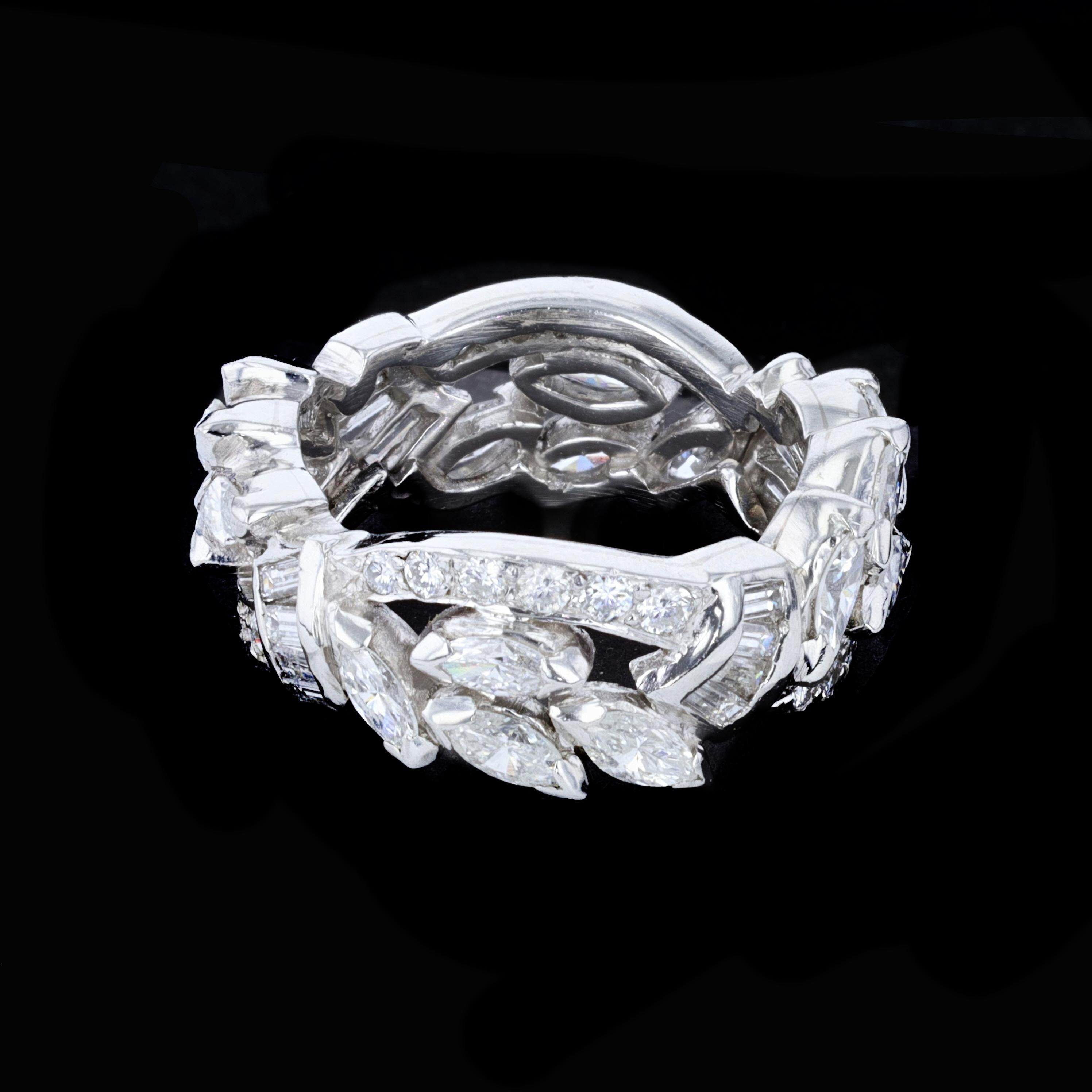 This platinum mid-century diamond full anniversary band features layers of sparkle and beauty containing 16 marquise, 16 baguette, and 24 round diamonds weighing 2.75 ctw and sized to 5 3/4.

