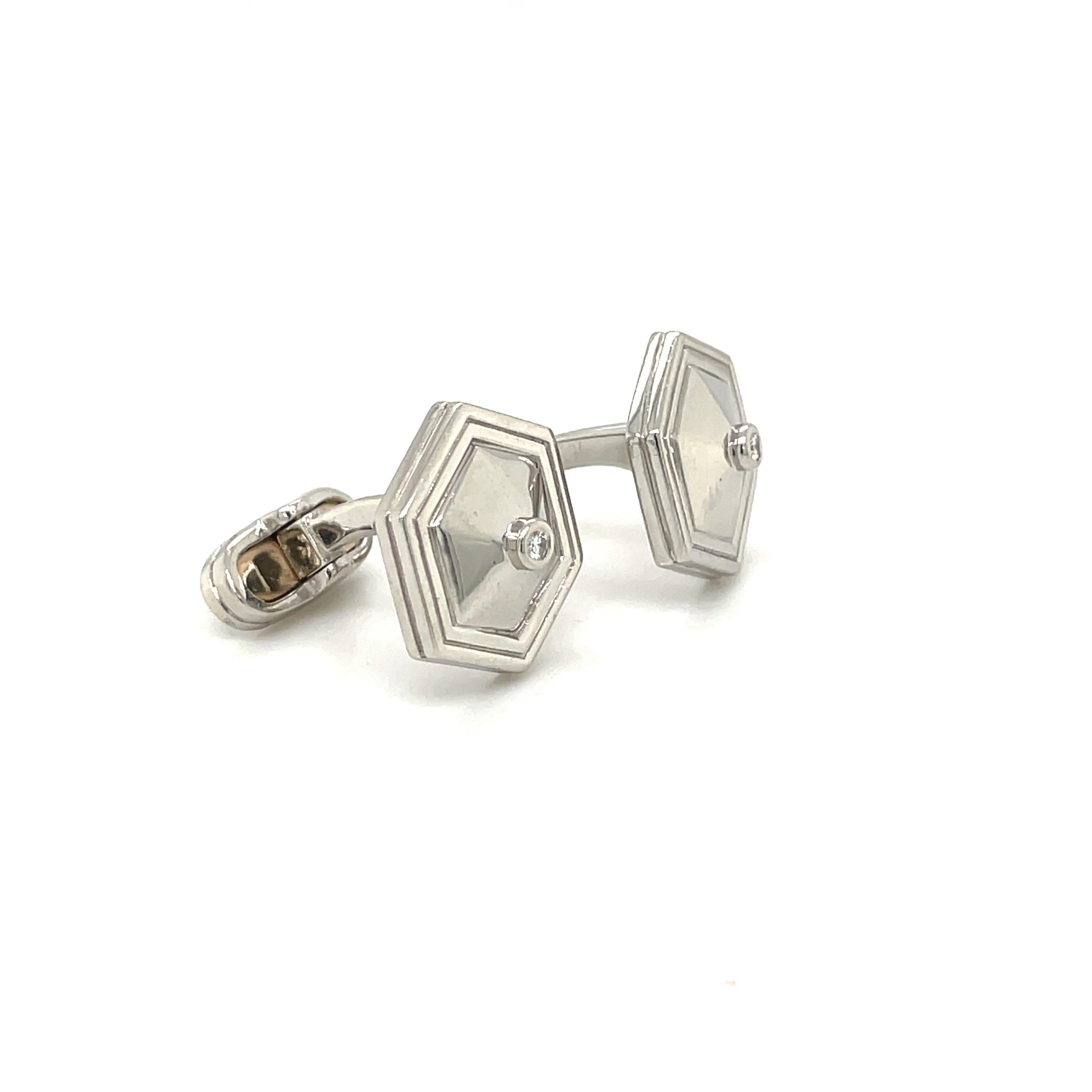 Classic platinum cuff links in a hexagon shape with bezel set round diamond centers. The hexagons measure 14.5 mm in diameter.
Signed Mattis Plat