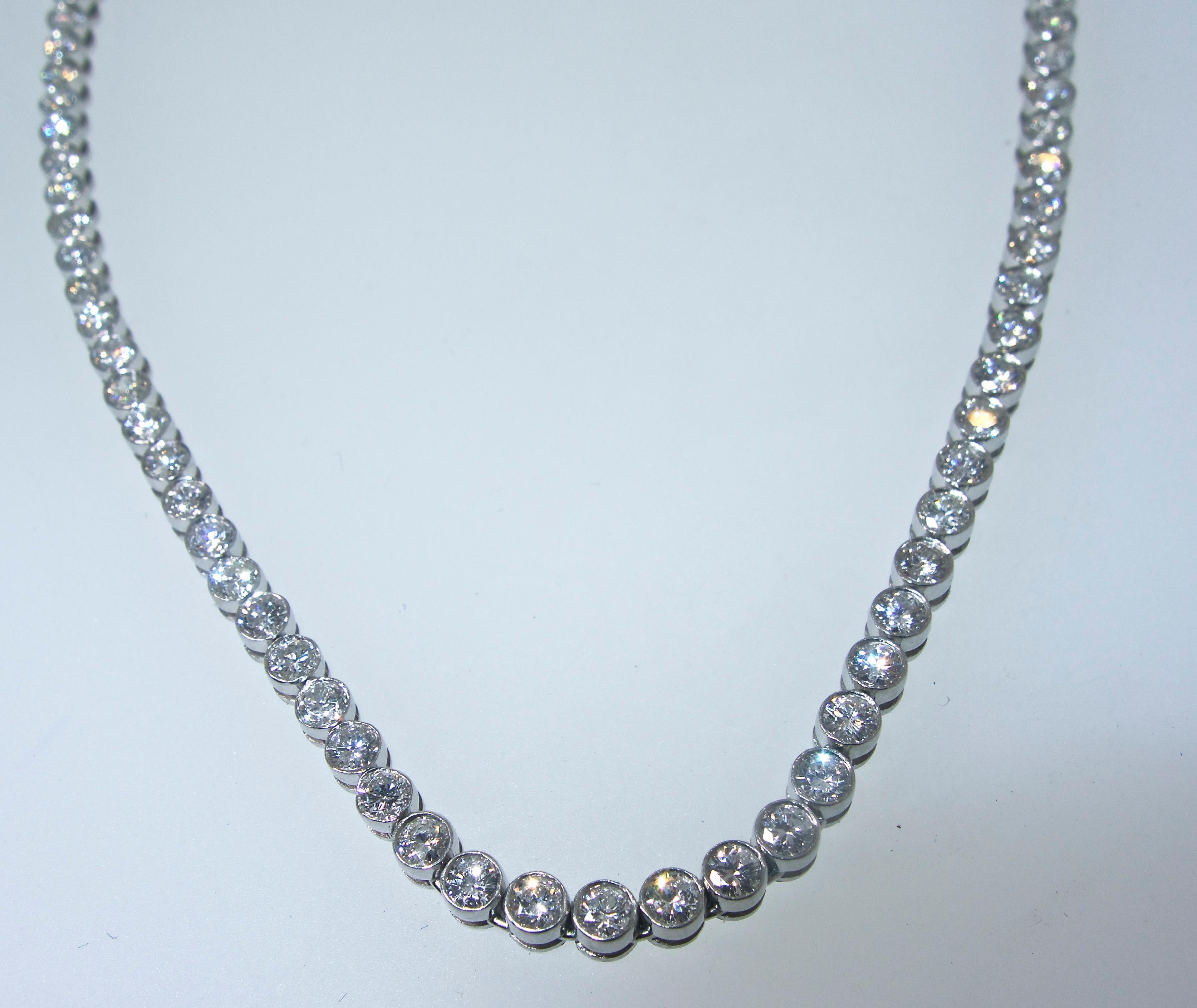 Diamond necklace with fine white brilliant cut diamonds. This well made necklace is platinum.  The diamonds slightly graduate in size from the largest at the center then graduating in size with the smallest stones at the clasp.   The total diamond