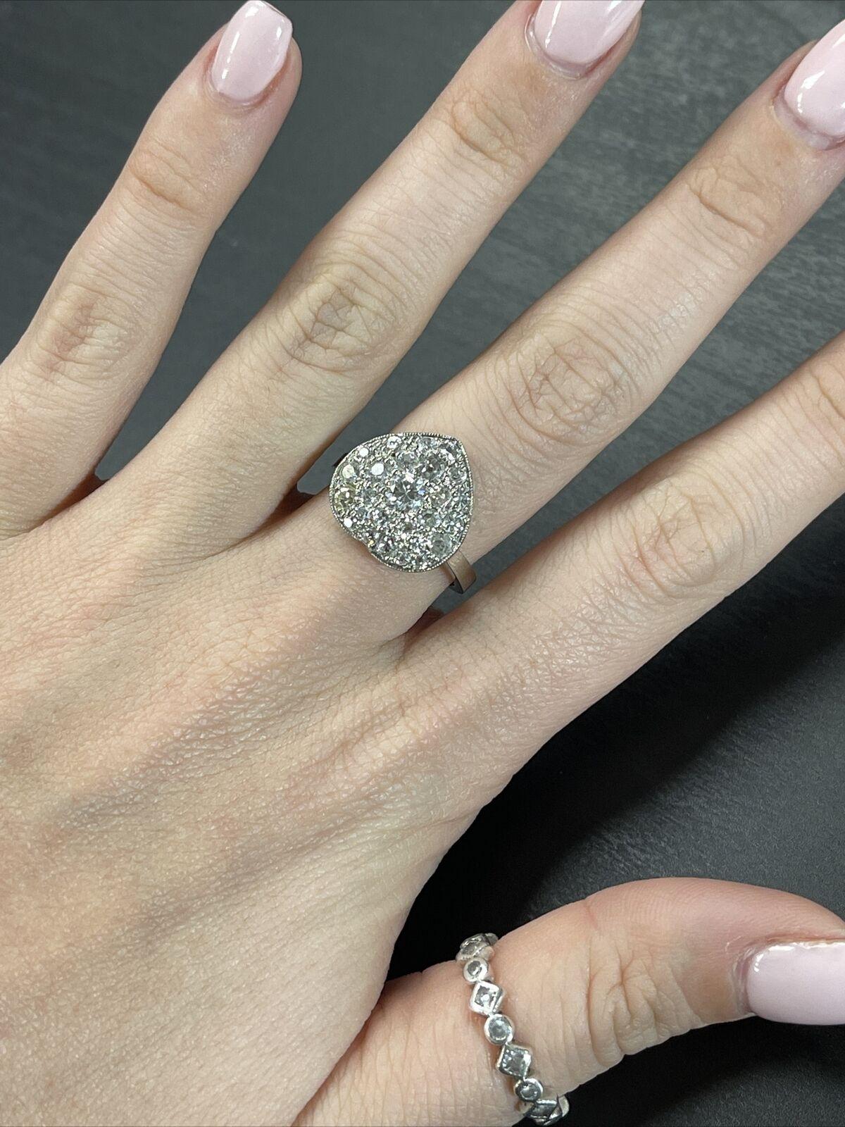 Presenting a

Platinum and Diamond Pave Old Mine Cut Diamond Heart Ring Size 7

A sparkling ring featuring 1.6 carats of natural mine cut diamonds pave set in a sold platinum dome heart shaped ring.

G-J color with VS-SI2 clarity. One diamond is