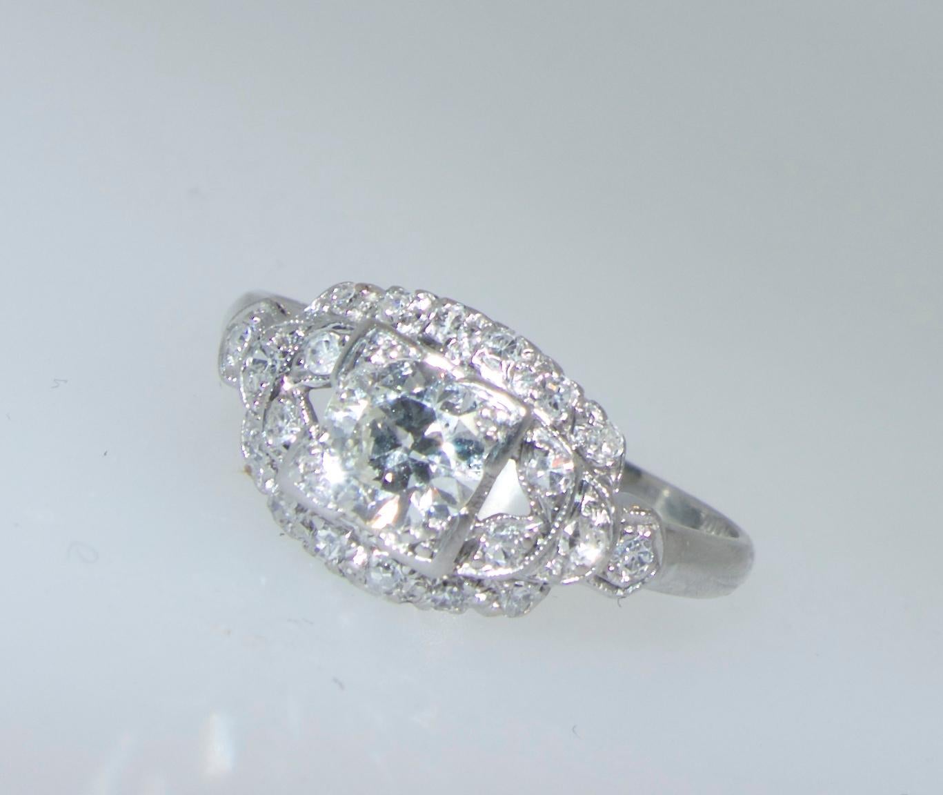 Vintage platinum ring circa 1930's with a center 1.0 fine faint color and very slightly included diamond accented with matching diamonds amounting to .33 cts.  This ring is a size 6