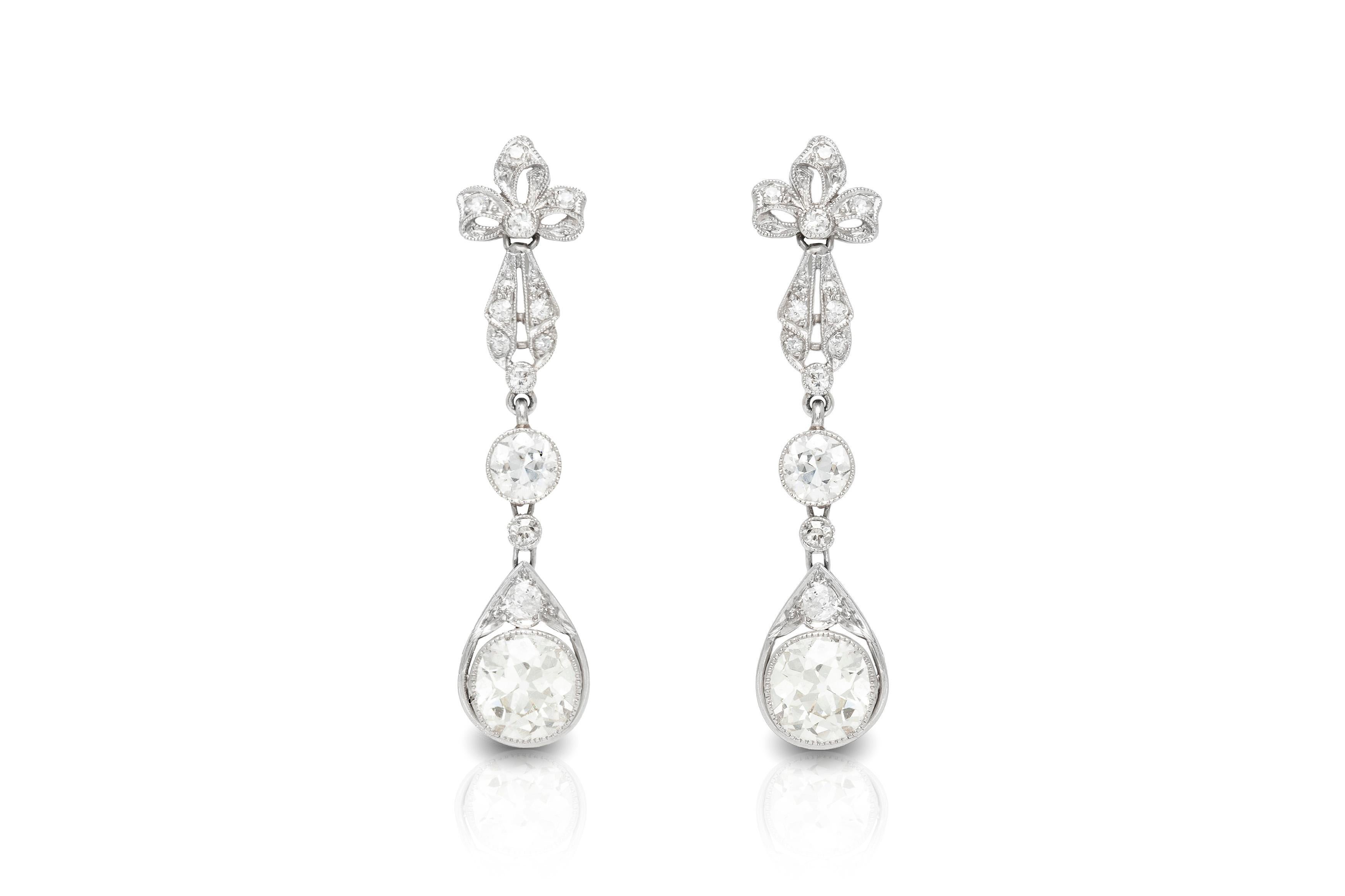 The earrings is finely crafted in platinum with two center diamonds weighing approximately total of 3.00 carat and all around diamonds weighing approximately total of 1.00.