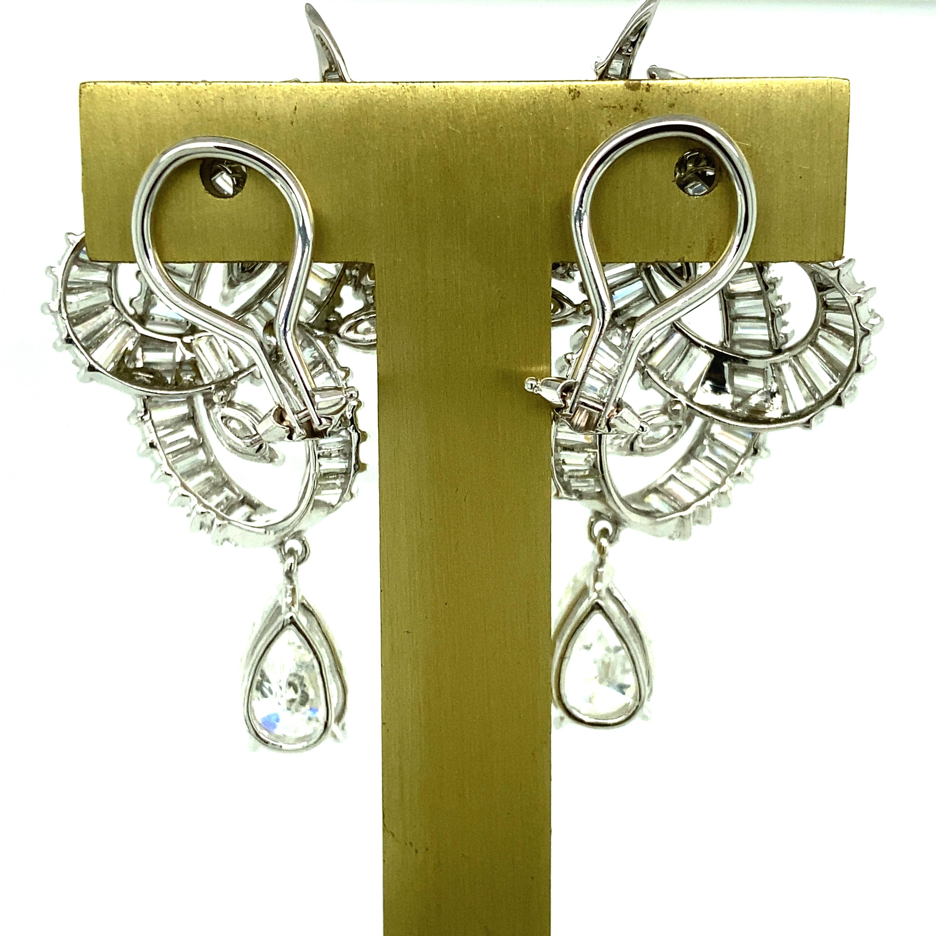 One pair of platinum and 14 karat white gold diamond clip on earrings set with two pear shaped diamonds, approximately 3.50 carat total weight with matching I-J color and I1 clarity, sixteen marquise cut diamonds, approximately 2.00 carat total