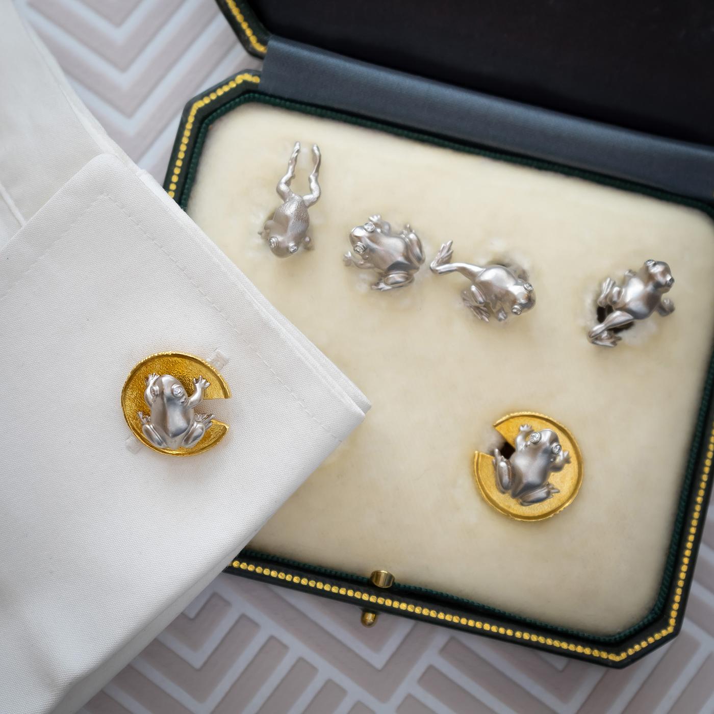 A frog dress-set, with four platinum studs, representing frogs in different positions, with diamond eyes, in rub-over settings and frog on yellow gold lily pad cufflinks, signed JB. Cufflinks measure approximately 19.6 x 19.2mm. Circa 1995.
