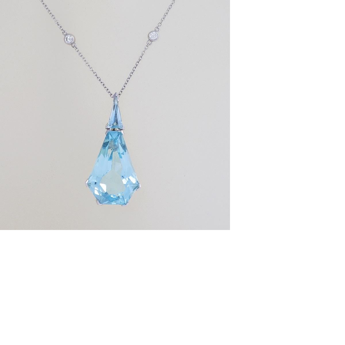A platinum and 14 karat gold necklace with aquamarine and diamonds. The necklace has one kite cut aquamarine with an approximate total weight of 17.39 carats, and a triangle aquamarine with an approximate total weight of 1.80 carats. The pendant is