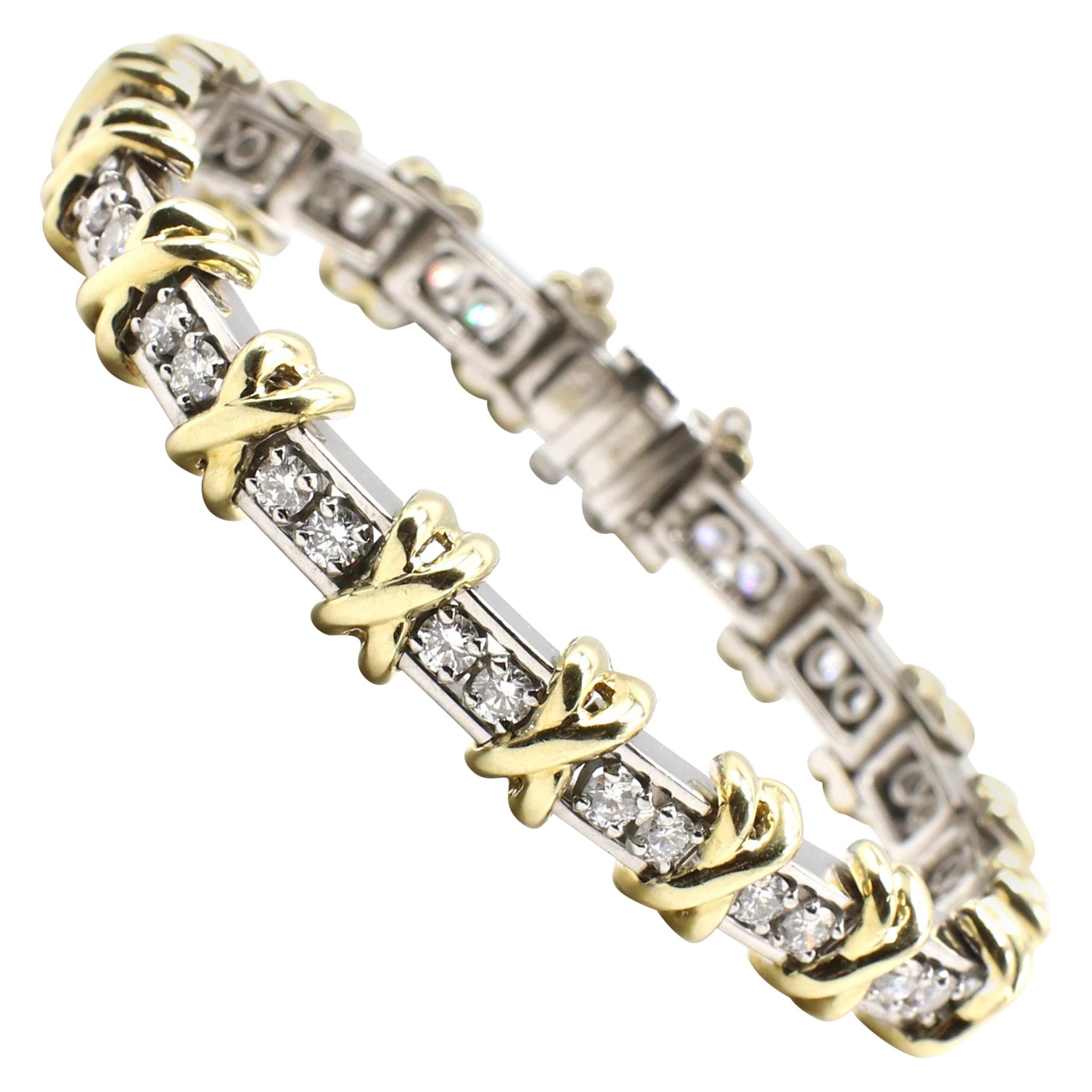 Platinum & Gold Two-Tone Diamond 3 CTW X Motif Tennis Bracelet 

Metal: Platinum & yellow gold
Weight: 47.5 grams 
36 Round Diamonds measuring approx. 3 ctw
Diamonds are approximately G-H in color and SI in clarity
Width: approx. 8mm at widest 
Fits
