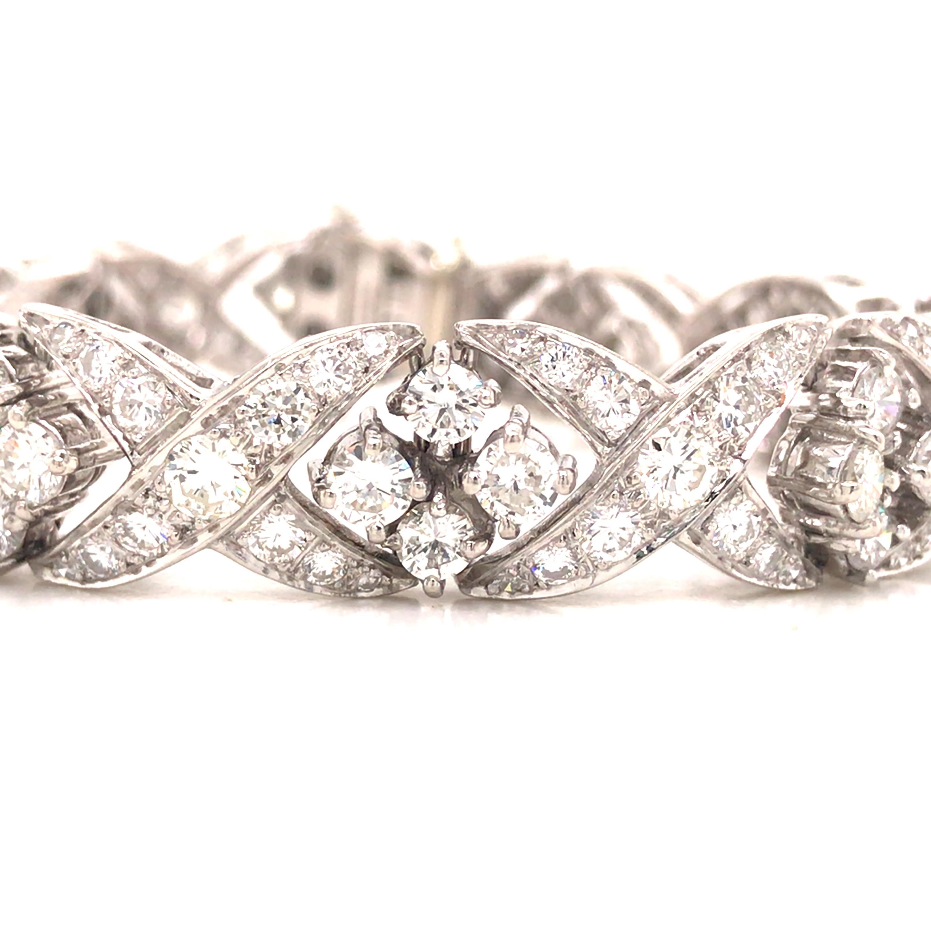 Diamond 'X' 'O' Bracelet in Platinum and Palladium.  Round Brilliant Cut Diamonds weighing 12.30 carat total weight, F-G in color and VS-SI in clarity are expertly set.  The Bracelet measures 7 inch in length and 1/2 inch in width. 39.65 grams.