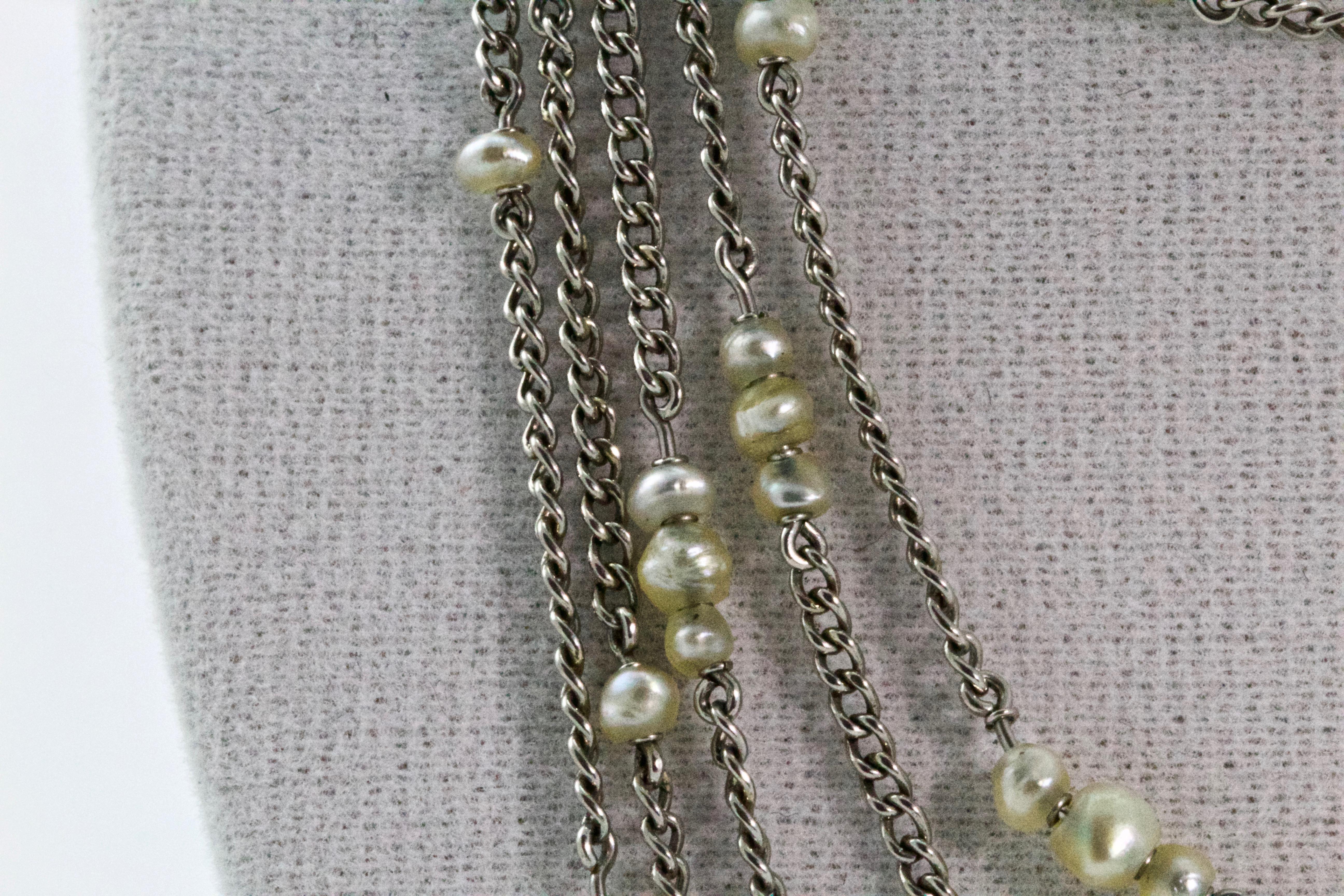 Fashioned circa 1920s this Art Deco long guard chain is comprised of platinum cable style links to give a chain of approximately 72 inches long. Beautifully embellished with 124 natural pearls. A lovely antique necklace that can be worn in many