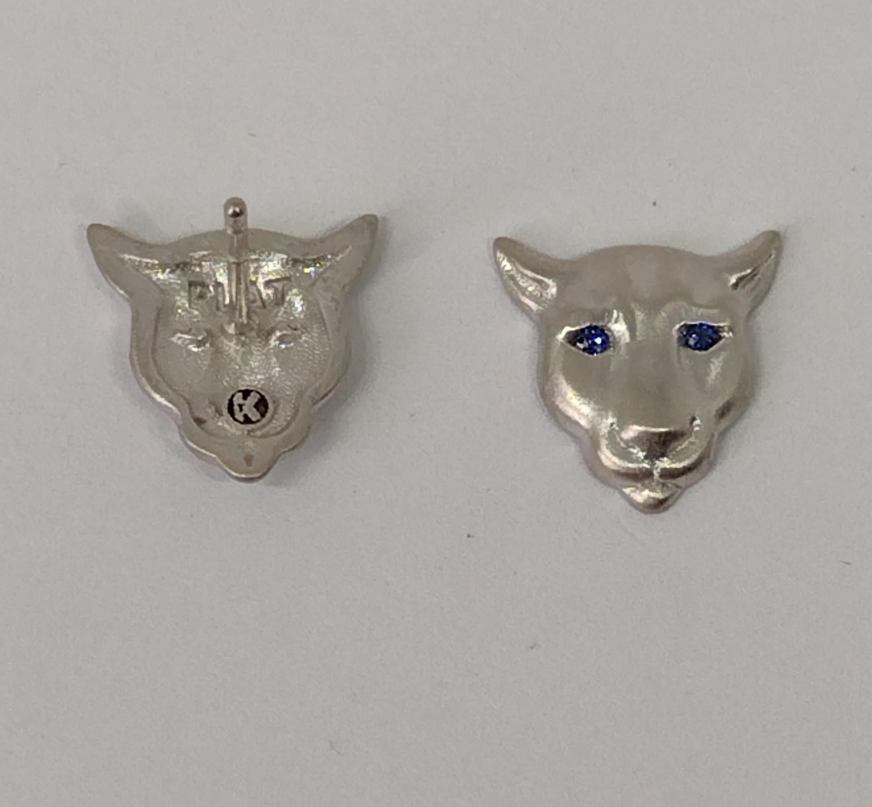 Platinum and Sapphire Eyes Colorado Cougar Stud Earrings, Tiffany Jewelry designer , Thomas Kurilla  is trying to keep the wild life at bay. They call it a mountain lion, panther, puma, or cougar . Just remember it has 4 legs, you have 2. Imagine