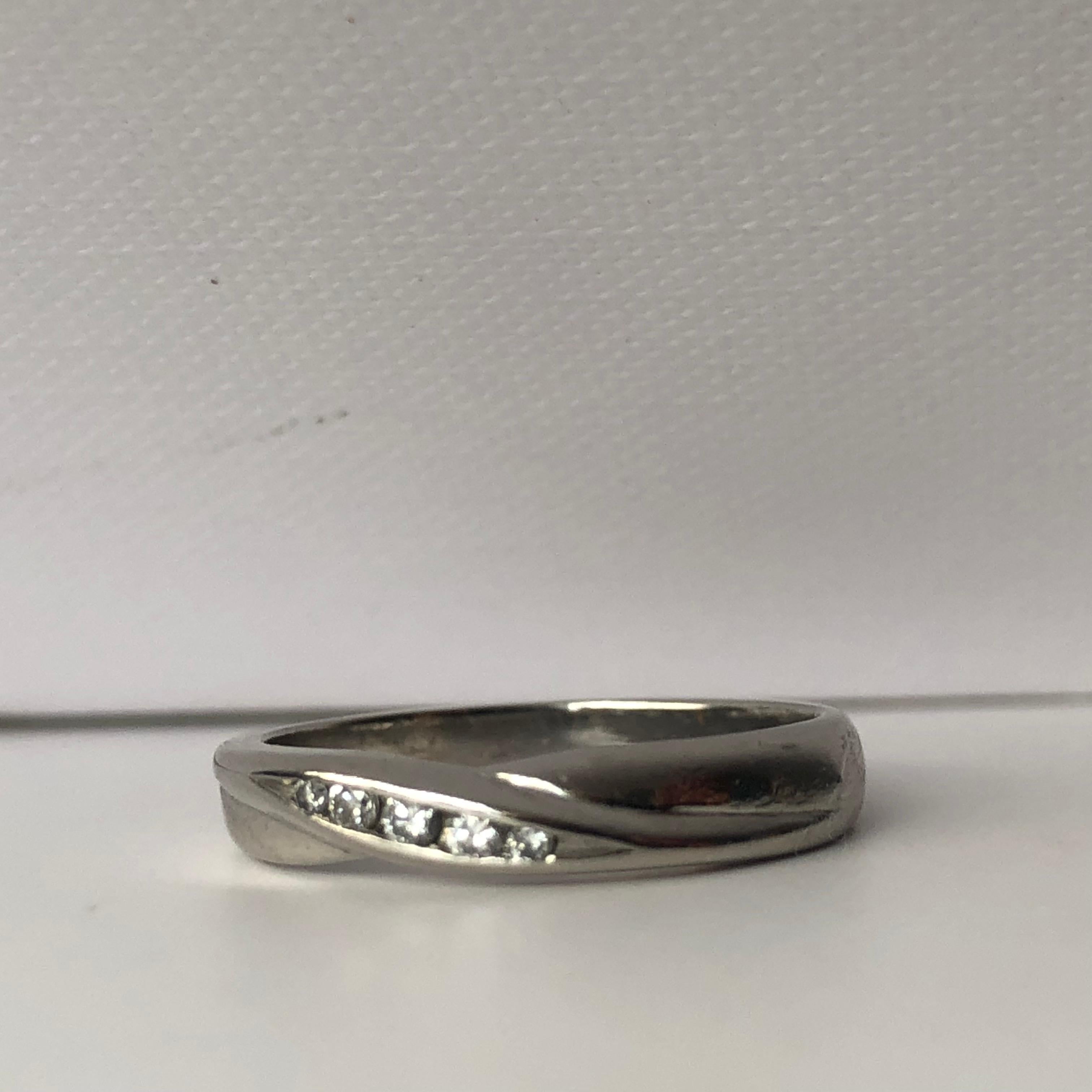 A Platinum & Diamond Wedding band

A Modern Slight Twist To The Diamond Setting 

Total White Brilliant Cut Diamond Weight .10ct 

Size L - Can Be sized for £20 