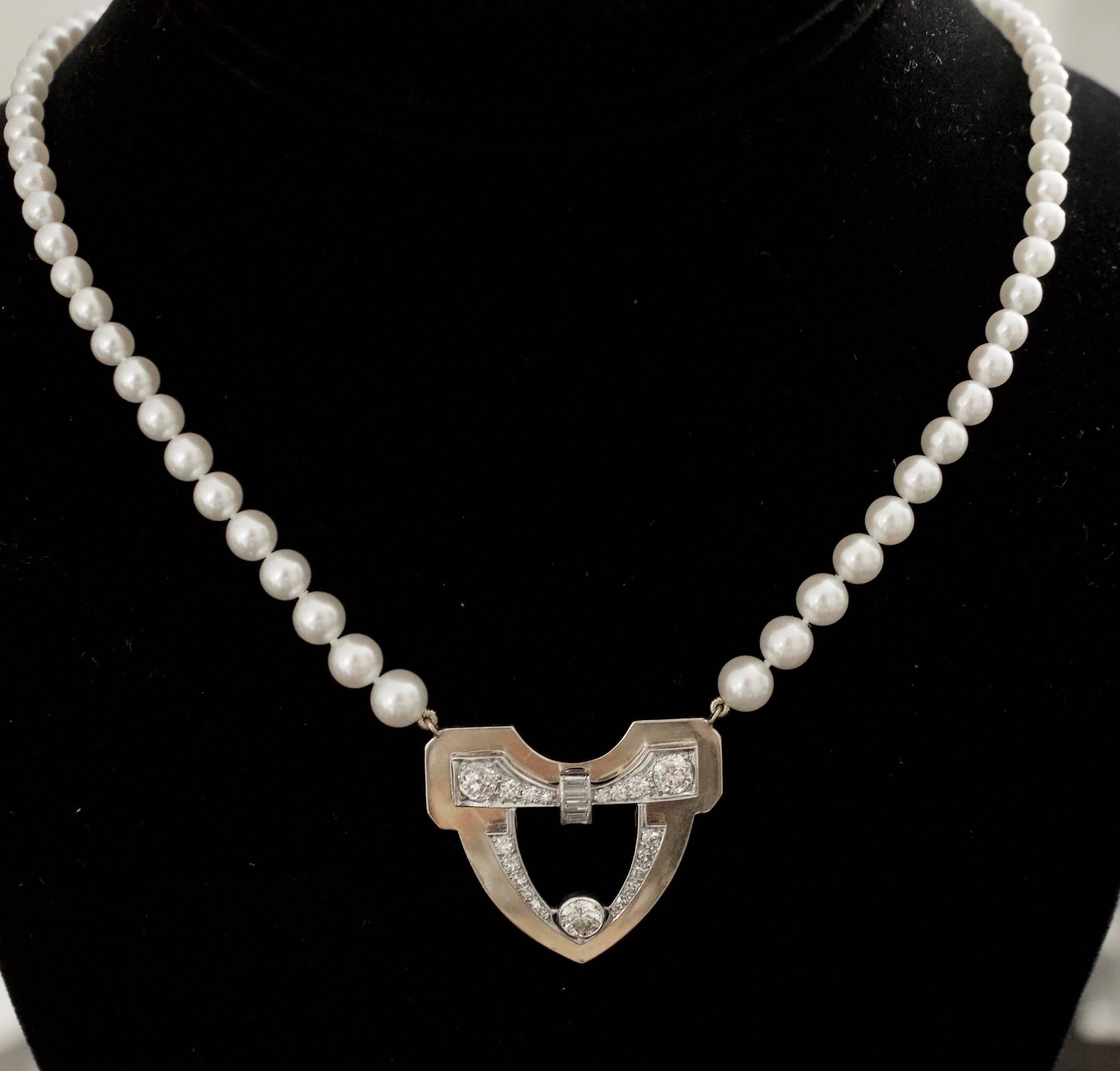 Platinum and Yellow Gold Circa 1930's-1950's Diamond and Pearl Neckllace
One Old European Cut Diamonds weighing .45 carats approximately [GH-VS2]
Twenty Round and Baguette  Cut Diamonds weighing 1.55 carats approximately [GH VS-SI]
Eighty Four Round