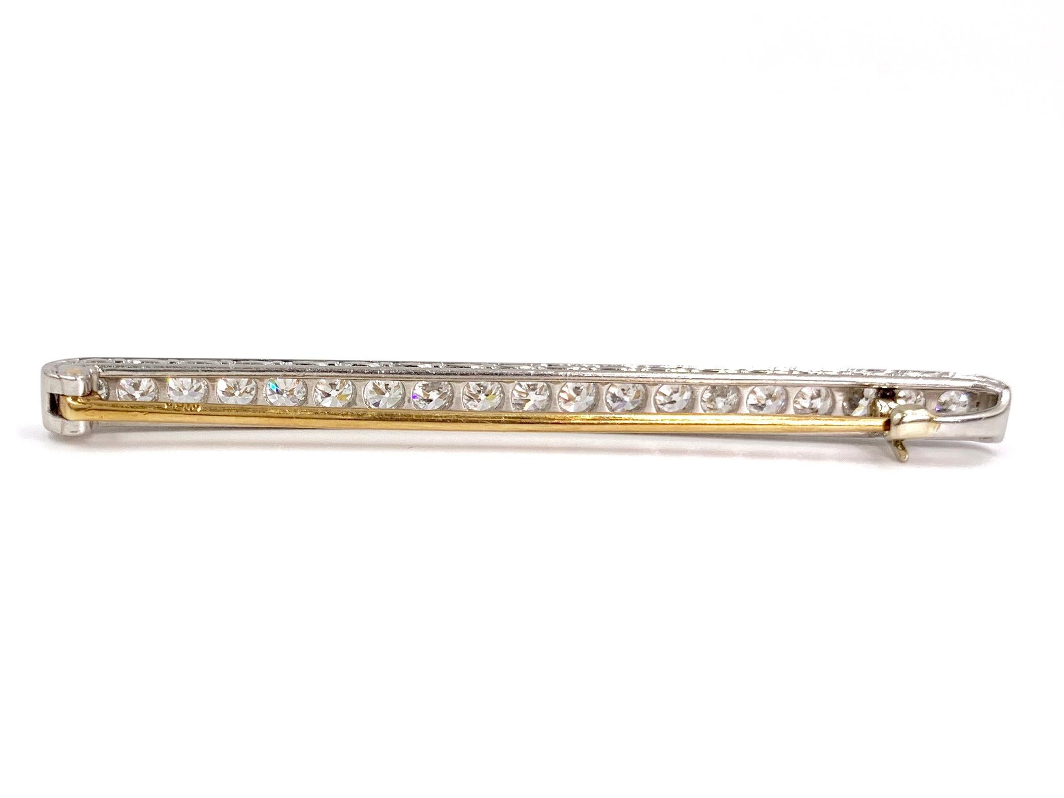 A beautiful and timeless platinum and 18 karat yellow gold Art Deco diamond bar brooch featuring 19 Old European cut diamonds at approximately 2.28 carats total weight. Diamonds have a generous amount of sparkle with grading of approximately G-H