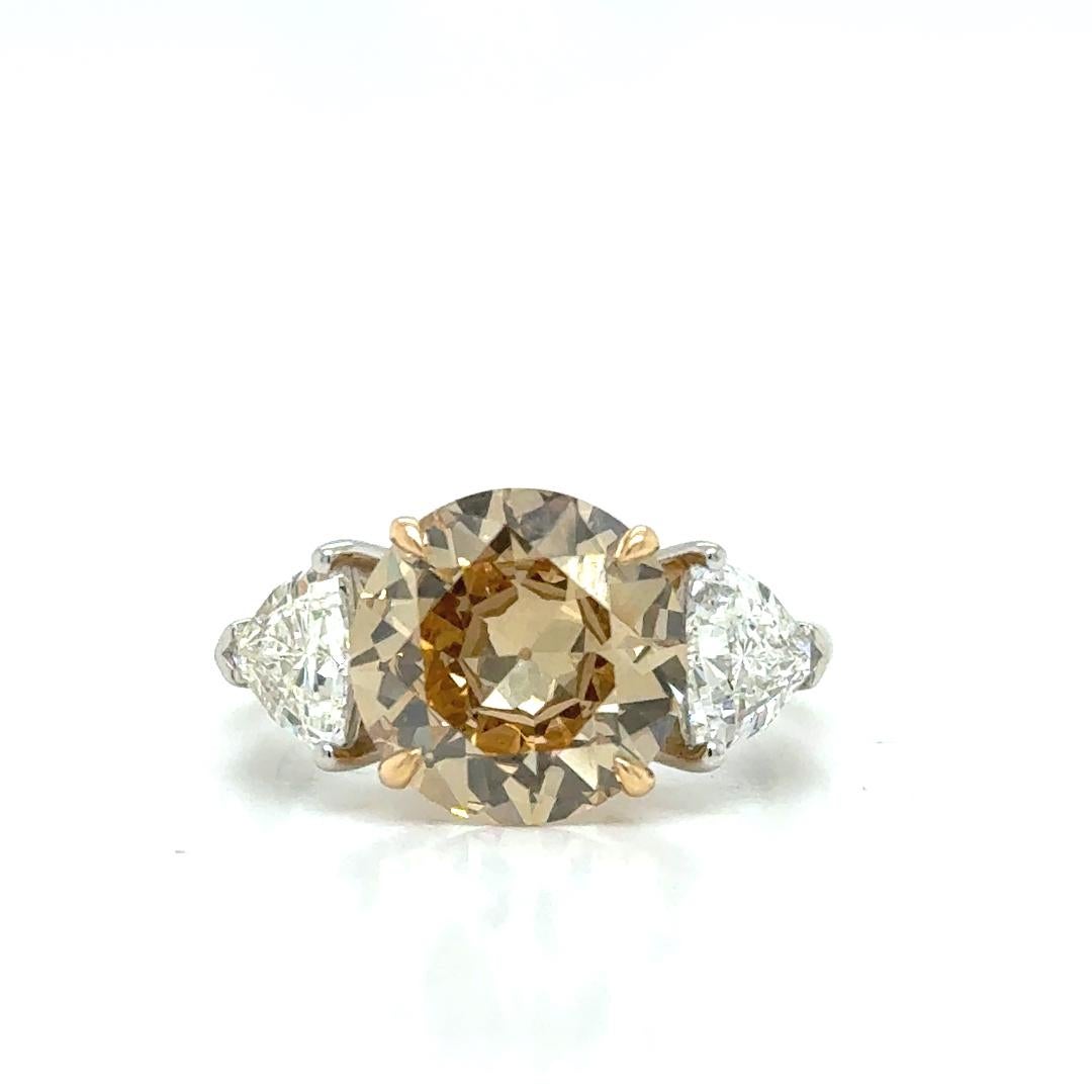 Elevate your jewelry collection with these breathtaking Yellow Gold and Platinum Ring with a Natural Fancy Yellowish Brown Diamond  3.21 cts GIA Certicated (10.22 x 10.24 x 4.85mm) Clarity VS2, adorned with and trillions diamonds 1.20 cts.

GIA