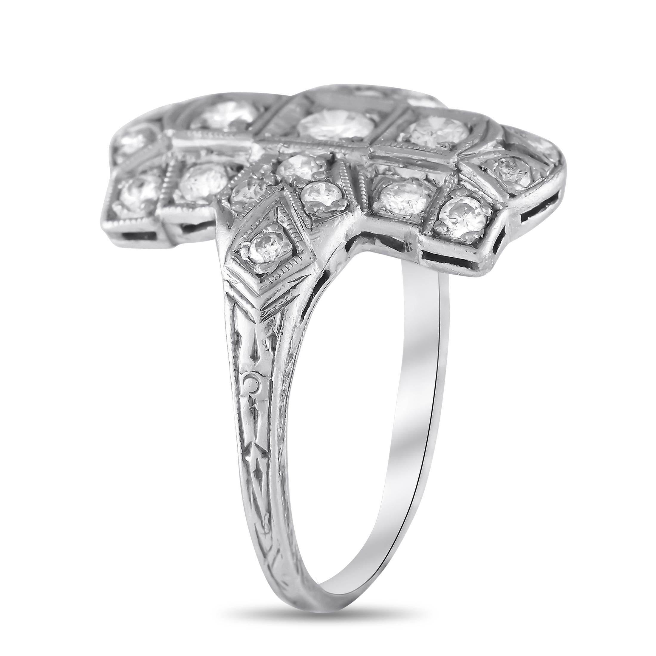 This antique ring is an easy way to add old fashioned elegance to any ensemble. Exquisite in design, the intricate Platinum setting comes to life thanks to inset Diamonds with a total weight of 0.60 carats. This timeless accessory features a 1mm