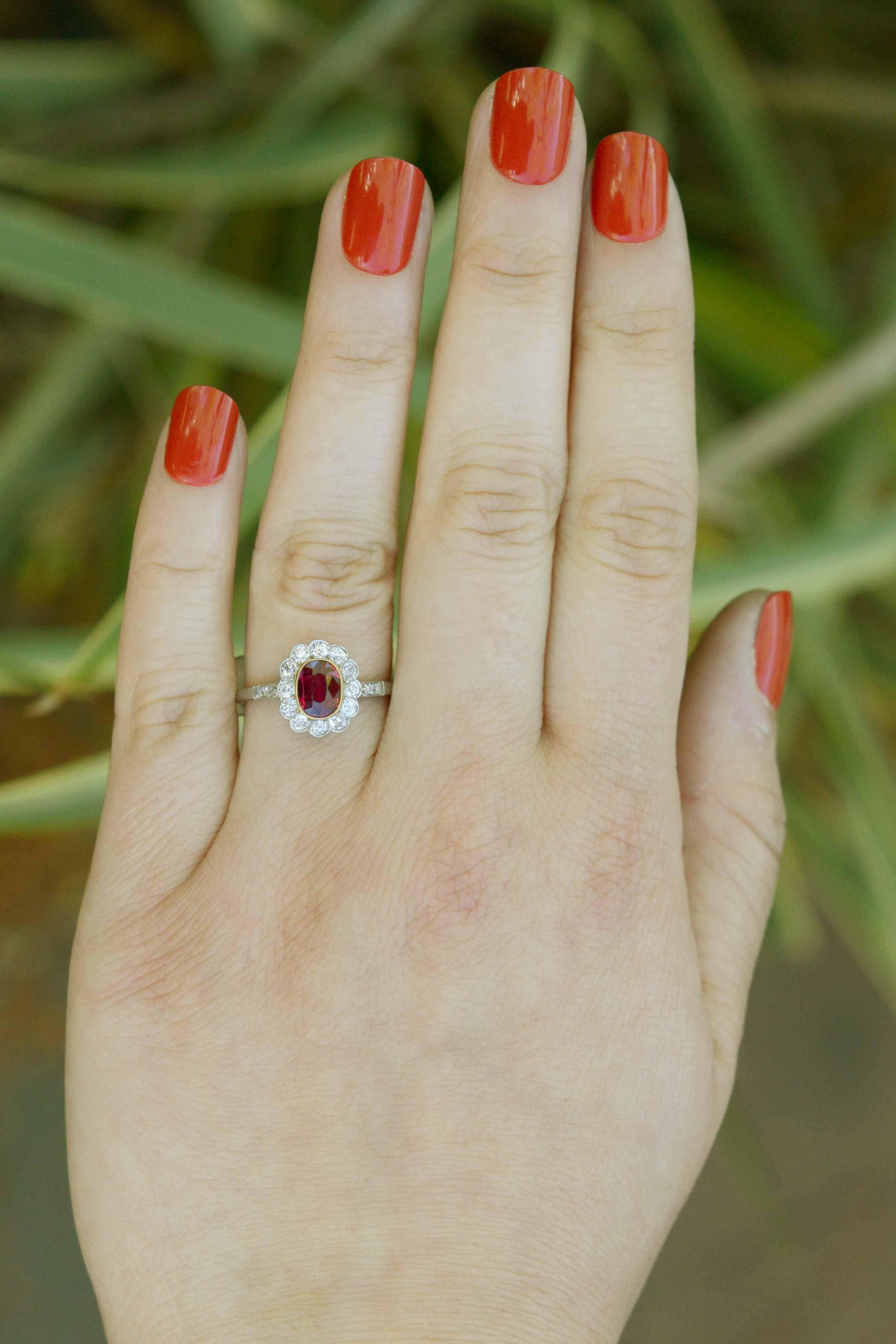 The DePalma antique ruby and diamond engagement ring is a classic Edwardian revival halo design. Lovingly restored from a circa 1900s bridal heirloom, the oval, 1 carat central ruby of a rich, pigeon blood red with a deeply saturated and lustrous