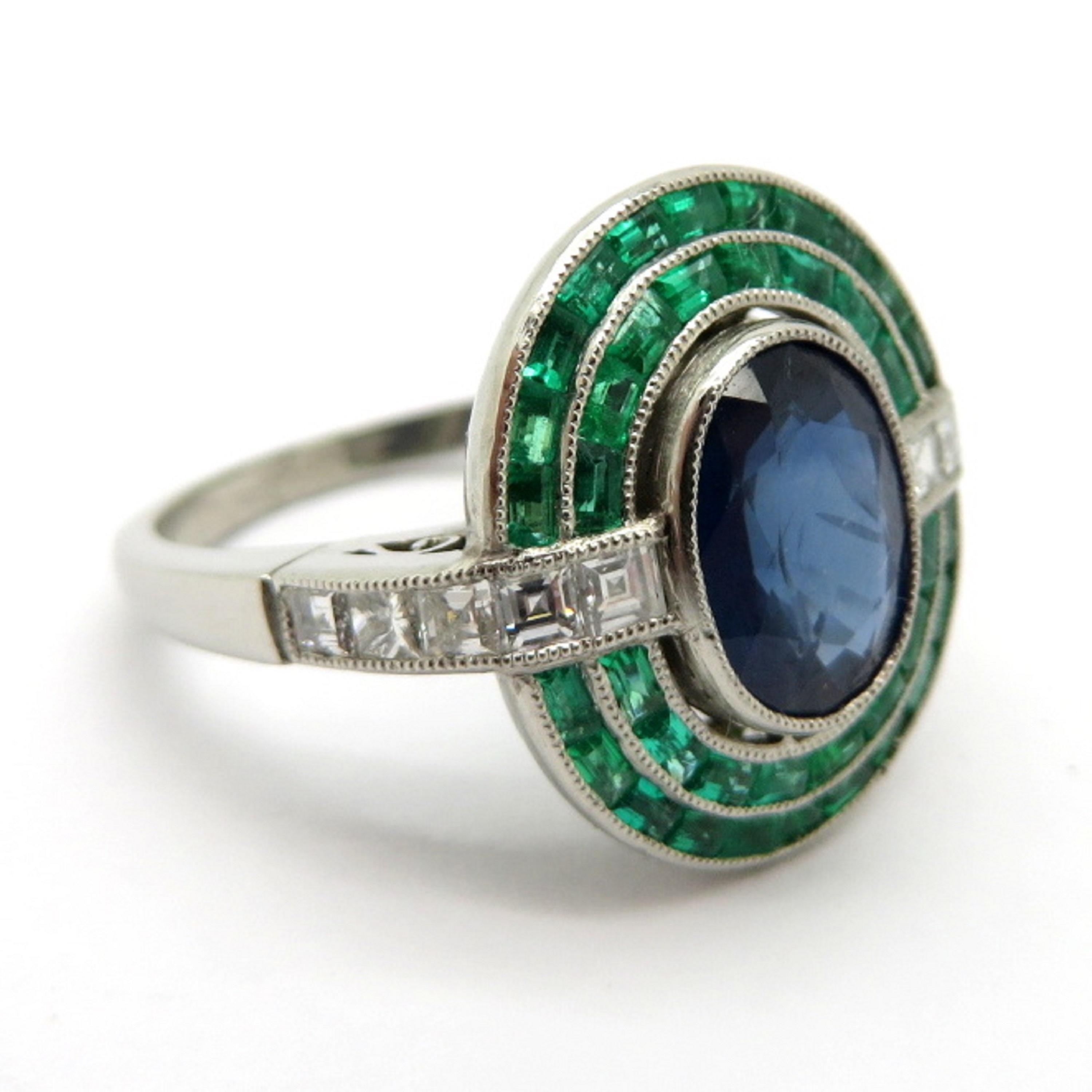 For sale is a beautiful estate Platinum Art Deco Ring with Sapphires, Emeralds and Diamonds!
Showcasing one (1) Oval Brilliant cut natural fine quality blue Sapphire, bezel set in a milgrain border, weighing approximately 2.07 carats.
Surrounding