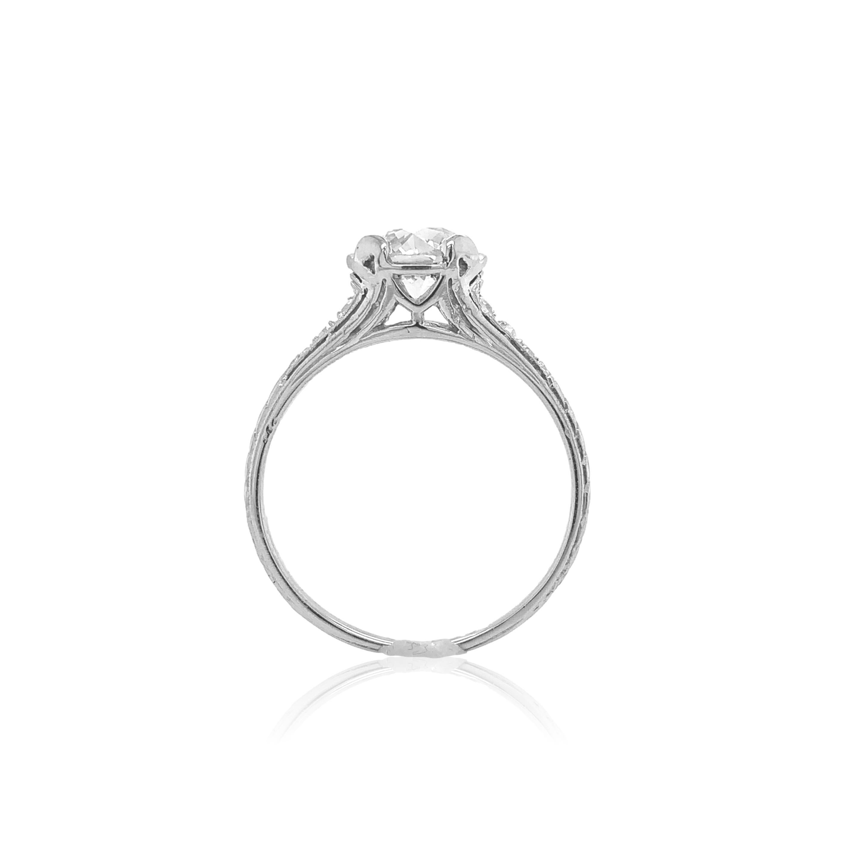 Art Deco platinum hand engraved 1.01 carat diamond engagement ring. The GIA report #6224599121 states circular brilliant cut natural diamond measuring 6.15mm x 6.35mm x 4.21mm with K color and VS1 clarity.  The diamond is set in 4 new prongs. There