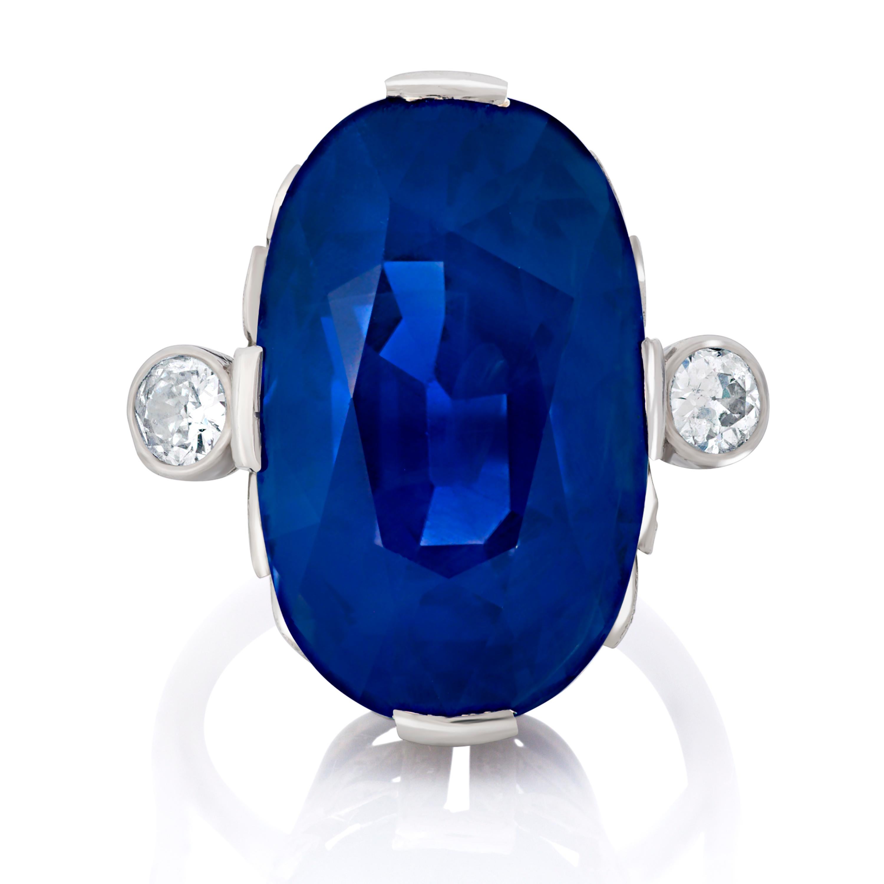 This sapphire and diamond ring in platinum is a perfect example of Art Deco style and craftsmanship, featuring an unheated 27.11 carat Ceylon (Sri Lanka) sapphire measuring 20.6 x 12.9 x 10.86mm, accompanied by both AGL and GIA reports.  The