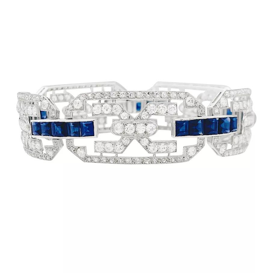A platinum Art Déco bracelet, made with geometrical motifs, enhanced with old and 8/8 cut diamonds (about 5 carats) and calibrated sapphires (about 15 carats). 
Safety chain, 18K white gold closing system. 
Diamonds : 5 carats
Sapphires : 15