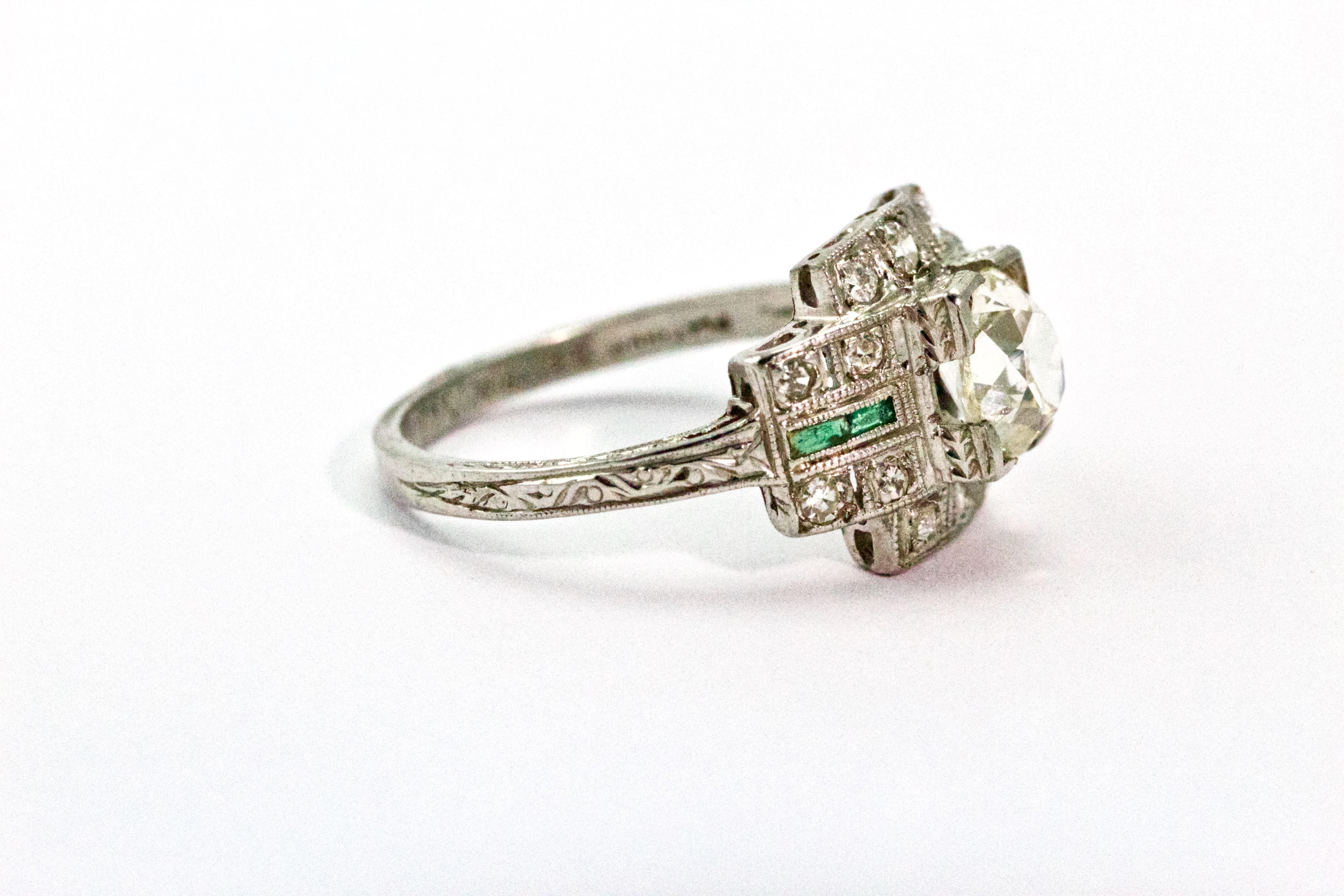 A wonderful 1920s antique cocktail ring with classic Art Deco styling is centred by a chunky-faceted Old European 85 point (approx) diamond of J/K color and SI2 clarity. The delightful 'cross' surround is set with 14 round cut diamonds and 4