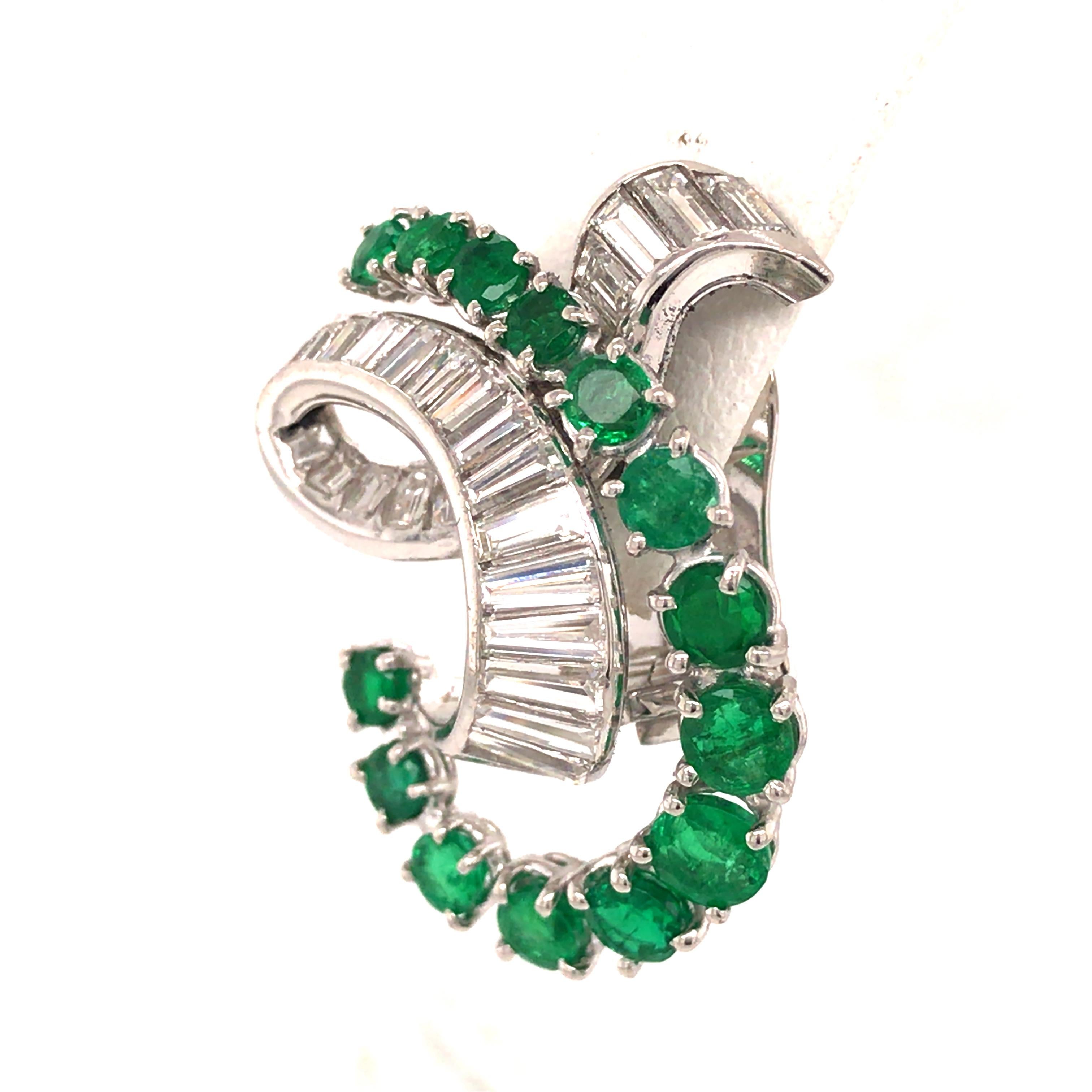 Art Deco Style Diamond and Emerald Earrings in Platinum.  (54) Baguette Diamonds weighing 4.43 carat total weight, G-H in color, VS-SI in clarity and (28) Round Green Emeralds weighing 4.19 carat total weight are expertly set.   The earrings measure