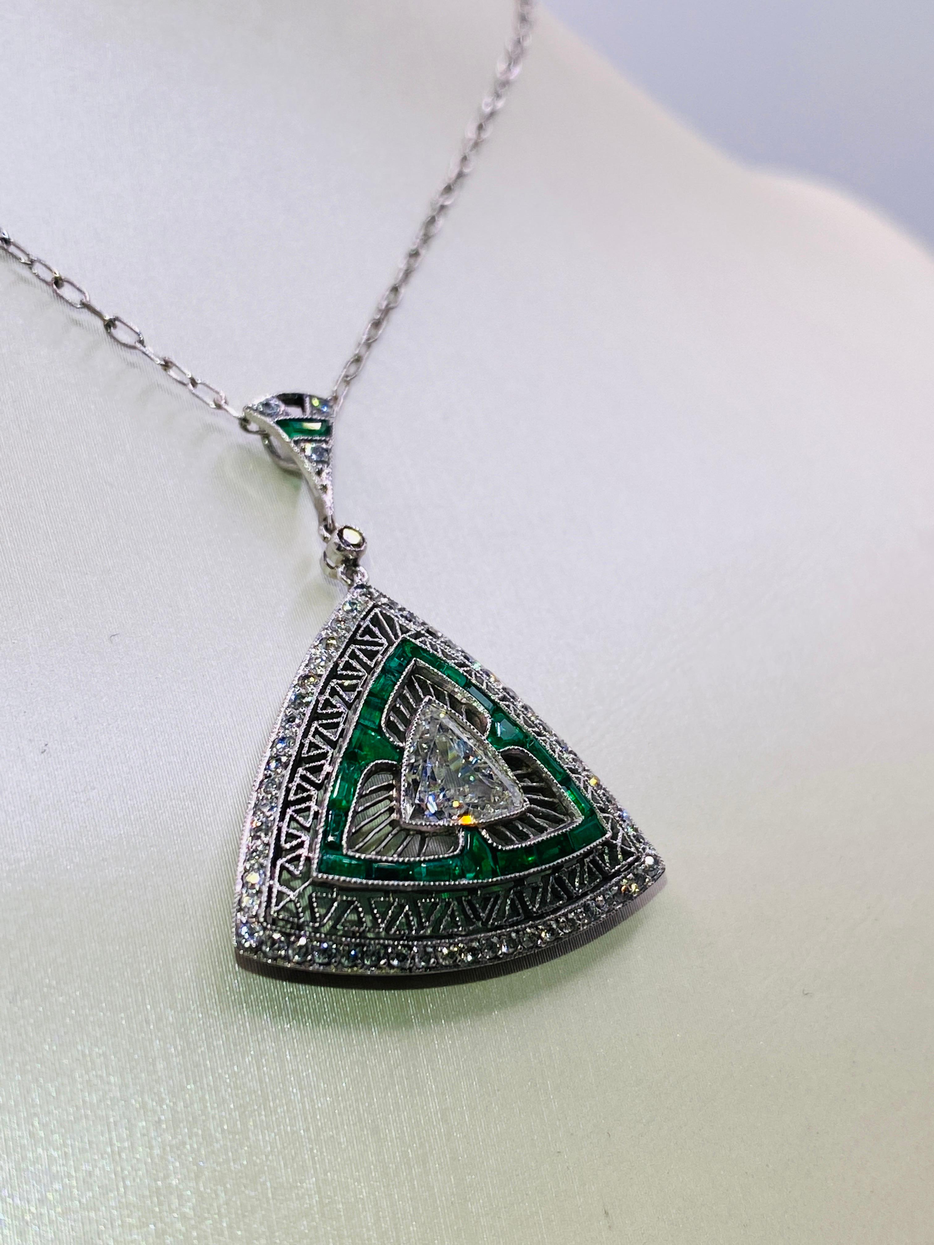 Platinum Art Deco necklace with 1.03 carat G/VS1 trillion center diamond, 1 carat total weight emeralds and .6 carat total weight brilliant round cut diamonds. 20